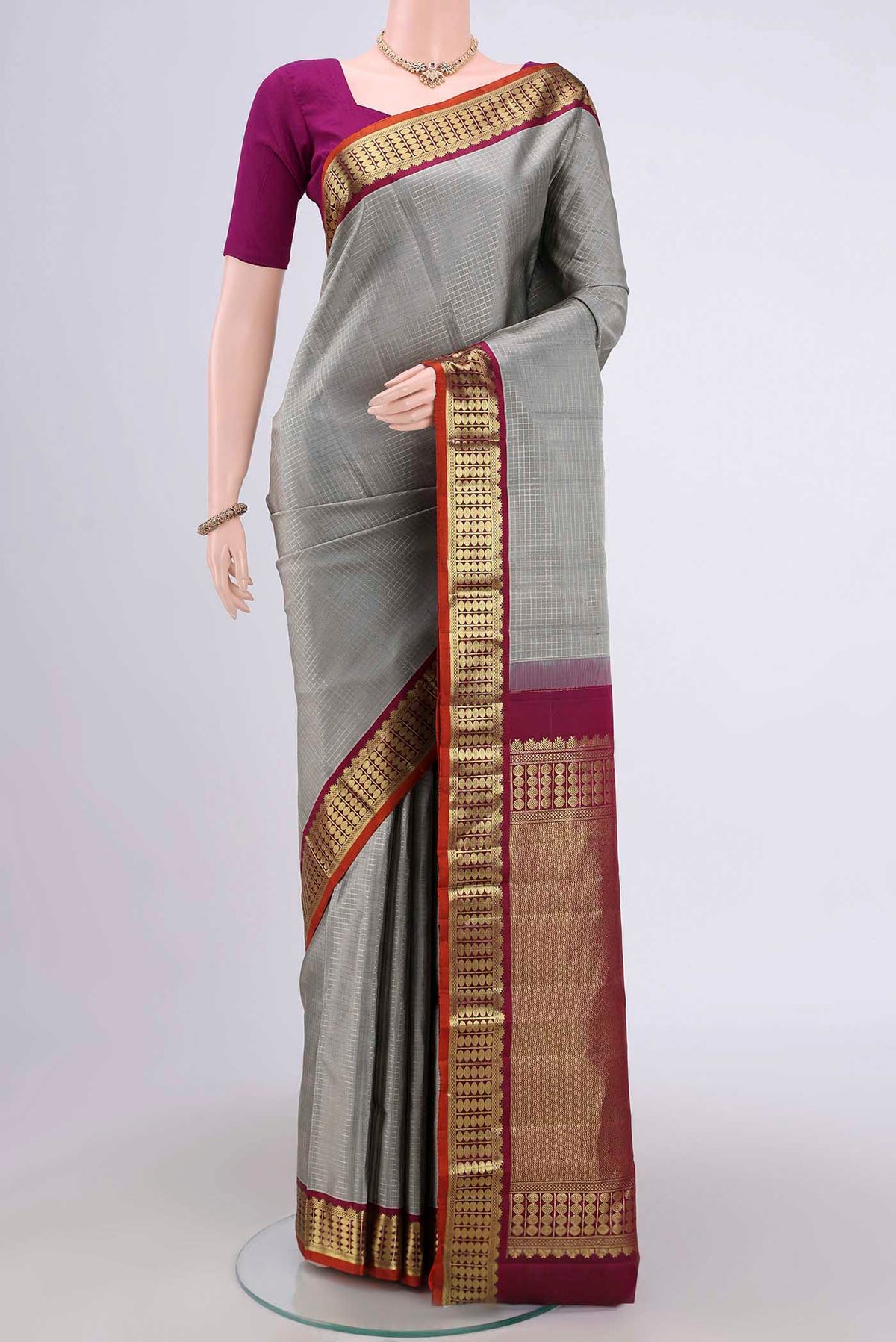 Grey Dual Tone Kanchipuram Saree with Checked design on the body and Zari Border.  displayed on a mannequin