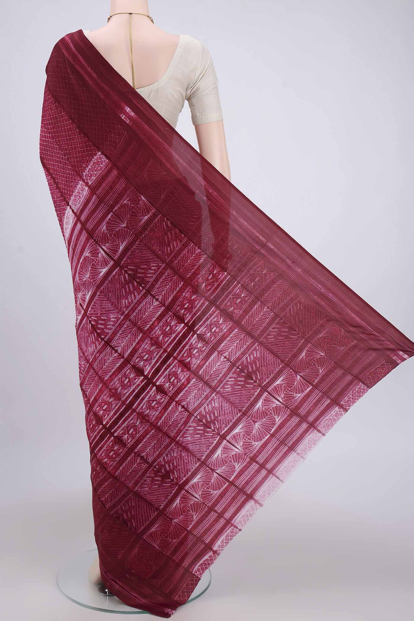 Flat view of Maroon Printed Silk Saree with Printed design on the body and Plain Border. 