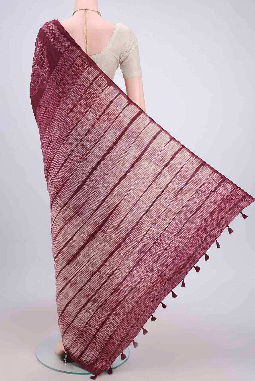 Flat view of Maroon Printed Silk Saree with Printed design on the body and Plain Border. 