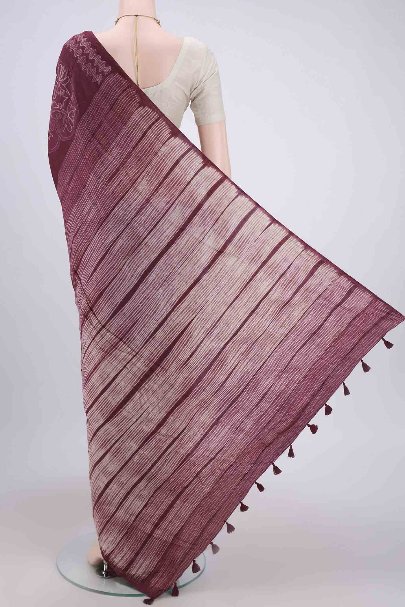 Flat view of Maroon Printed Silk Saree with Printed design on the body and Plain Border. 