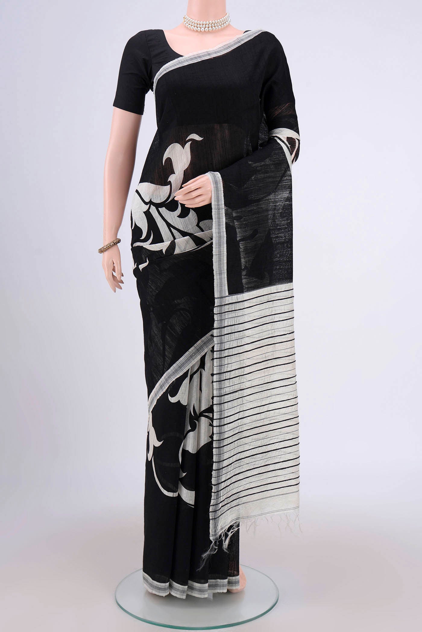 Black Dual Tone Tussar Silk Saree with Printed design on the body and Zari Border.  displayed on a mannequin