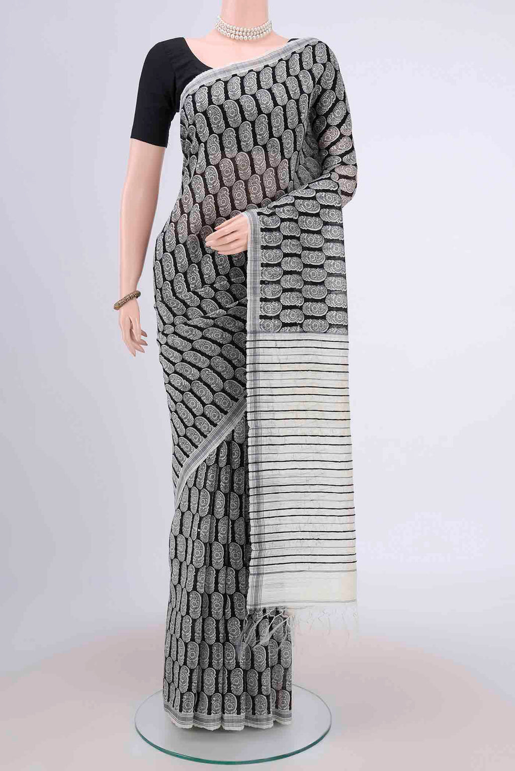 Black Dual Tone Tussar Silk Saree with Printed design on the body and Zari Border.  displayed on a mannequin