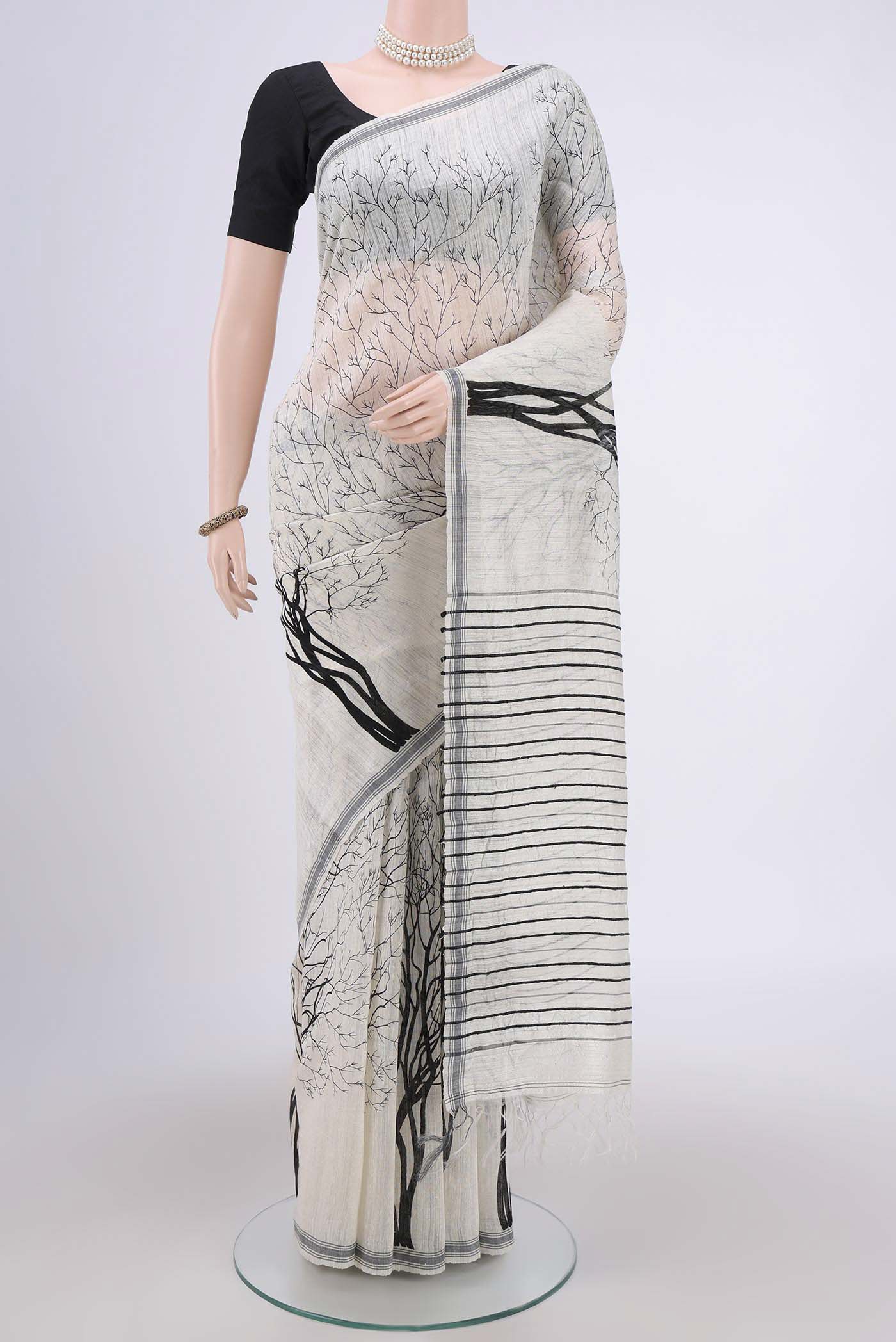 Pearl White Dual Tone Tussar Silk Saree with Printed design on the body and Zari Border.  displayed on a mannequin