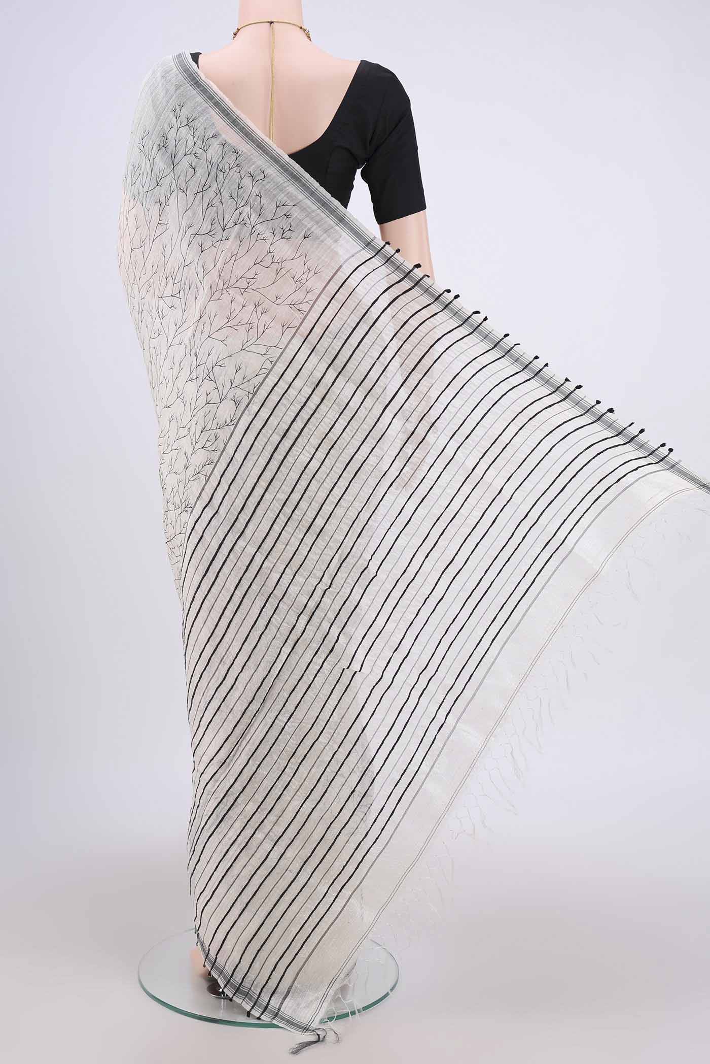 Flat view of Pearl White Dual Tone Tussar Silk Saree with Printed design on the body and Zari Border. 