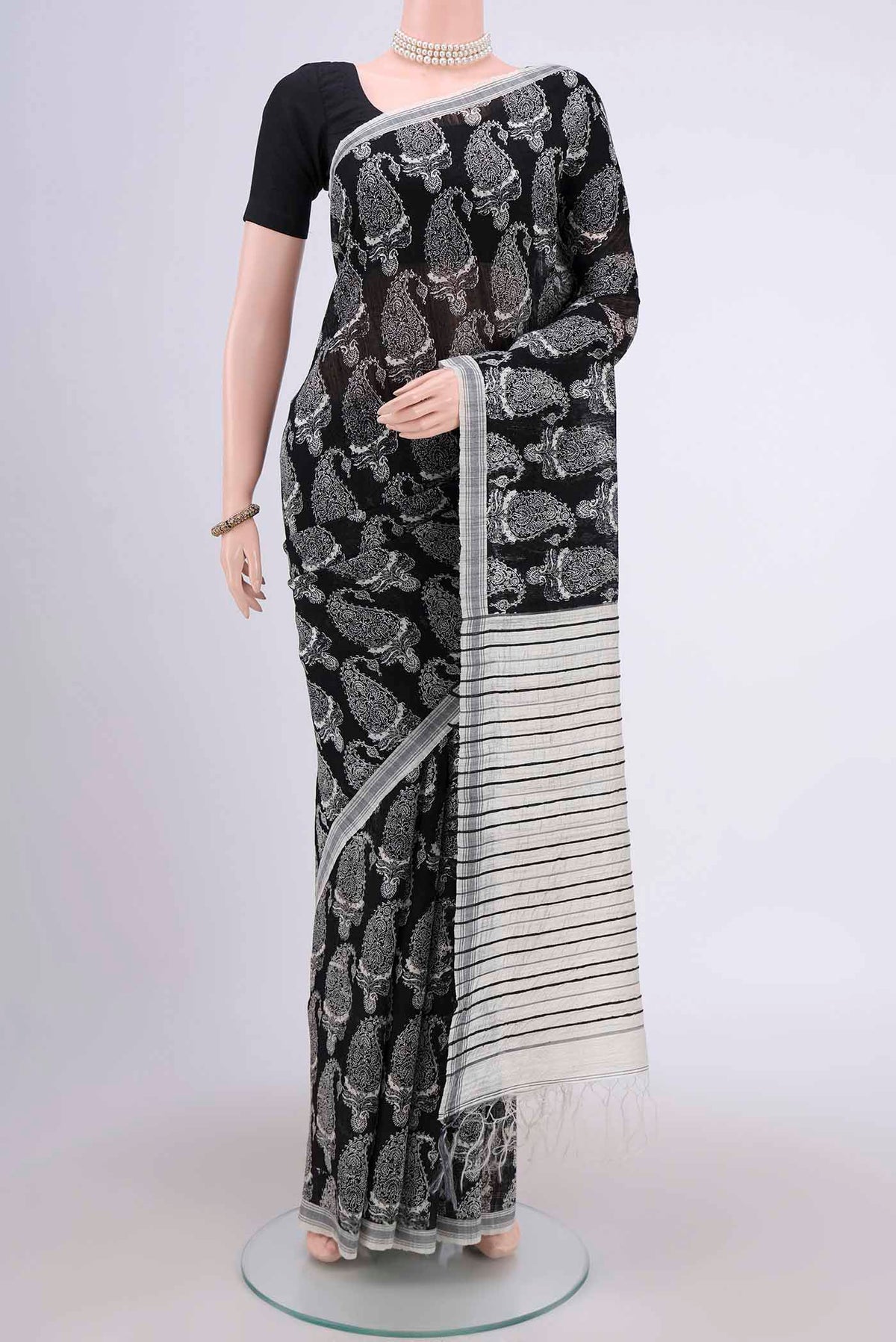Black Dual Tone Tussar Silk Saree with Printed design on the body and Zari Border.  displayed on a mannequin