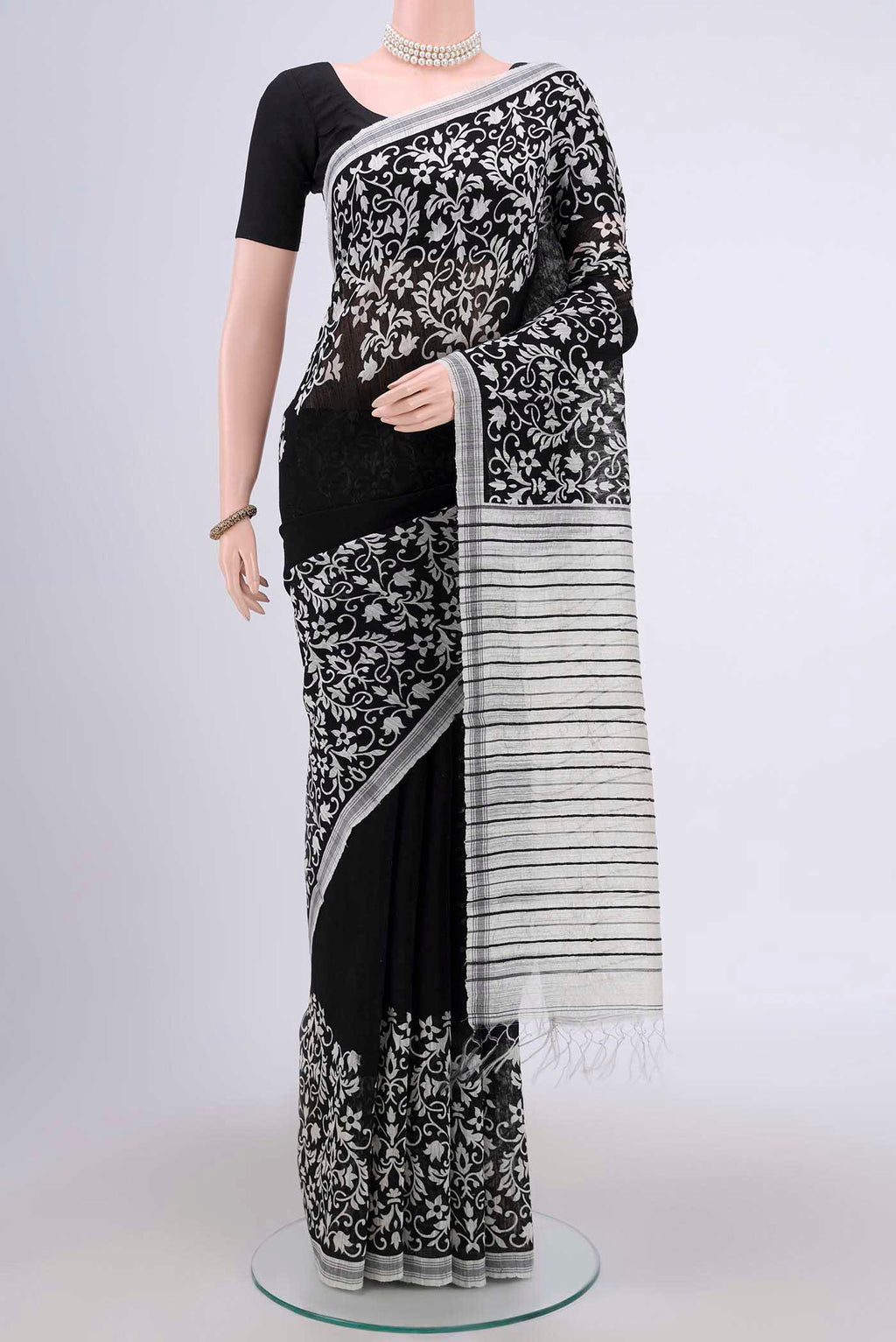 Black Dual Tone Tussar Silk Saree with Printed design on the body and Zari Border.  displayed on a mannequin