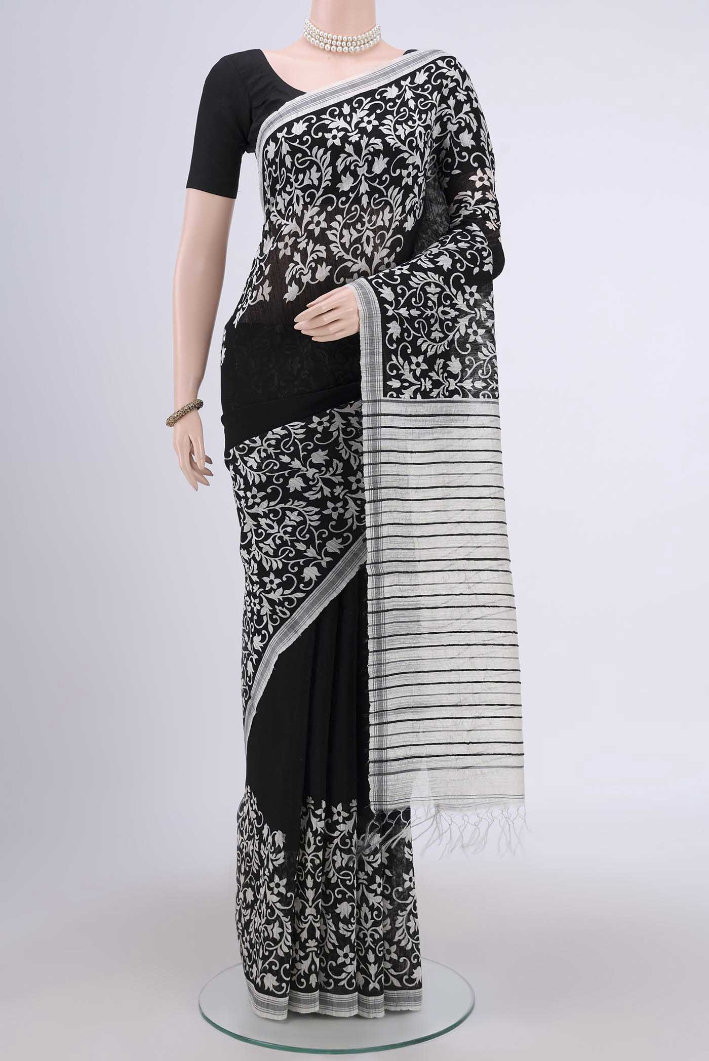 Black Dual Tone Tussar Silk Saree with Printed design on the body and Zari Border.  displayed on a mannequin