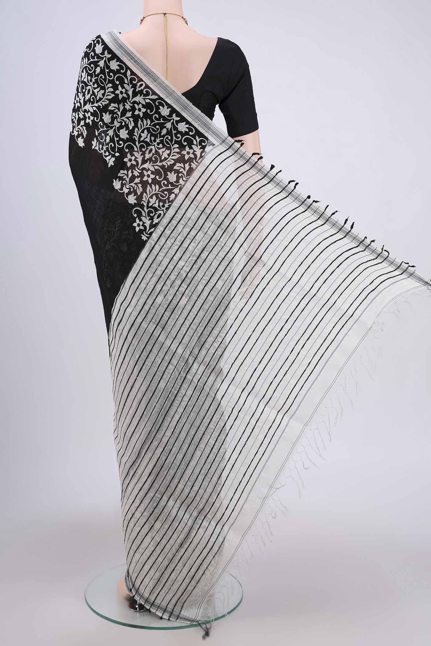 Flat view of Black Dual Tone Tussar Silk Saree with Printed design on the body and Zari Border. 