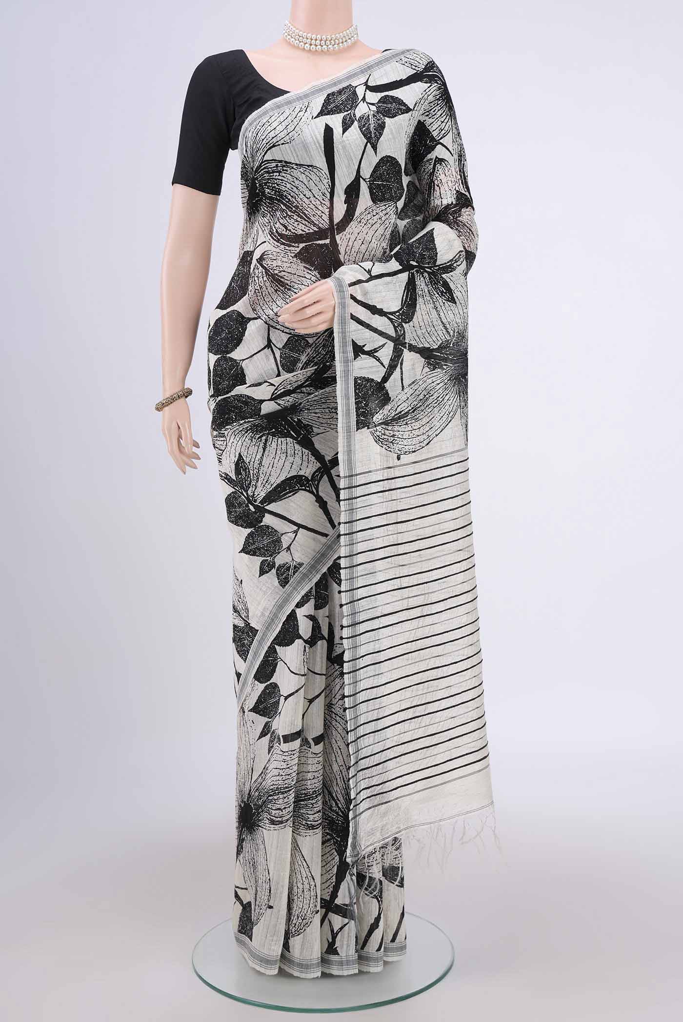 Pearl White Dual Tone Tussar Silk Saree with Printed design on the body and Zari Border.  displayed on a mannequin