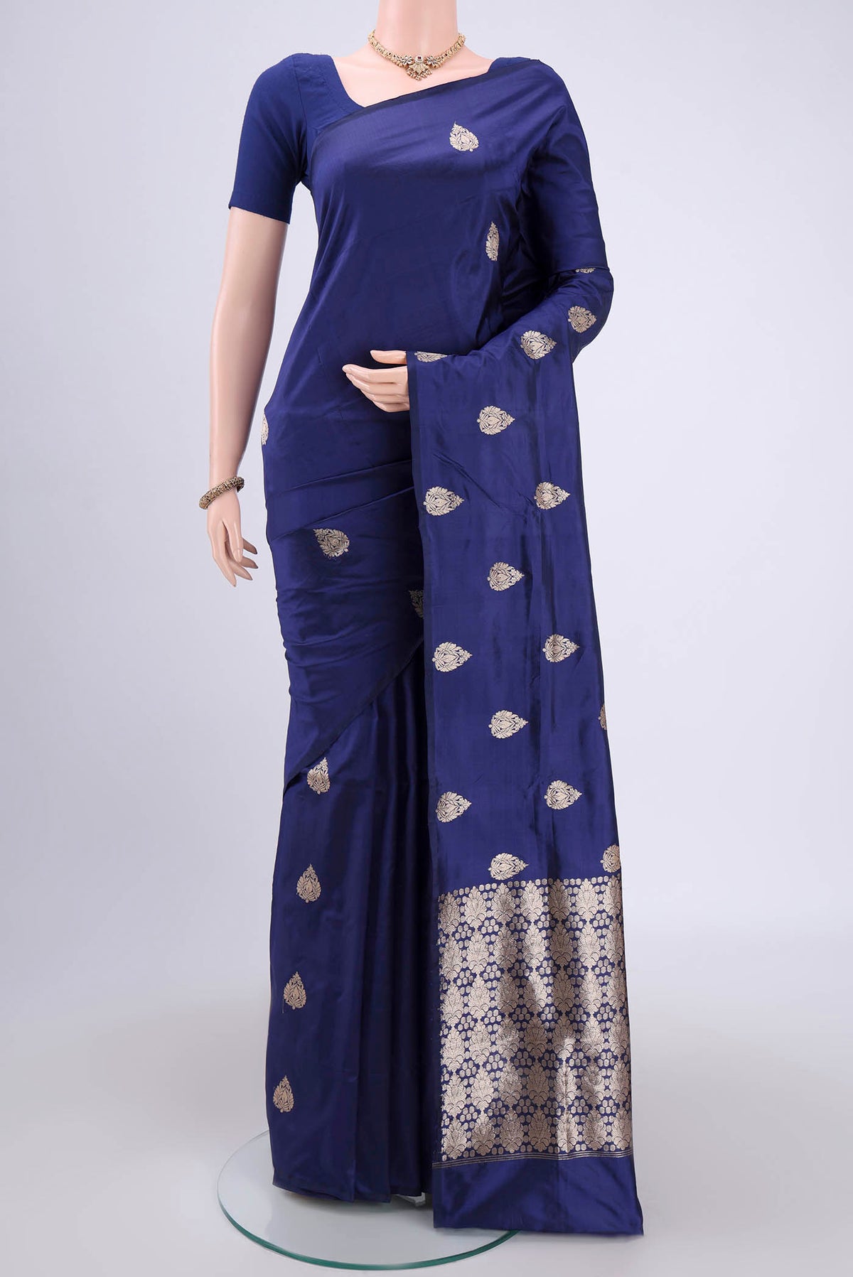 Blue Banarasi Katan Silk Saree with Zari Butta on the body and Zari Border.  displayed on a mannequin