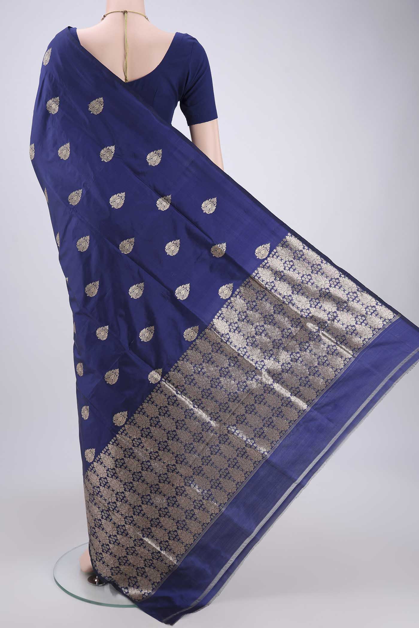 Flat view of Blue Banarasi Katan Silk Saree with Zari Butta on the body and Zari Border. 