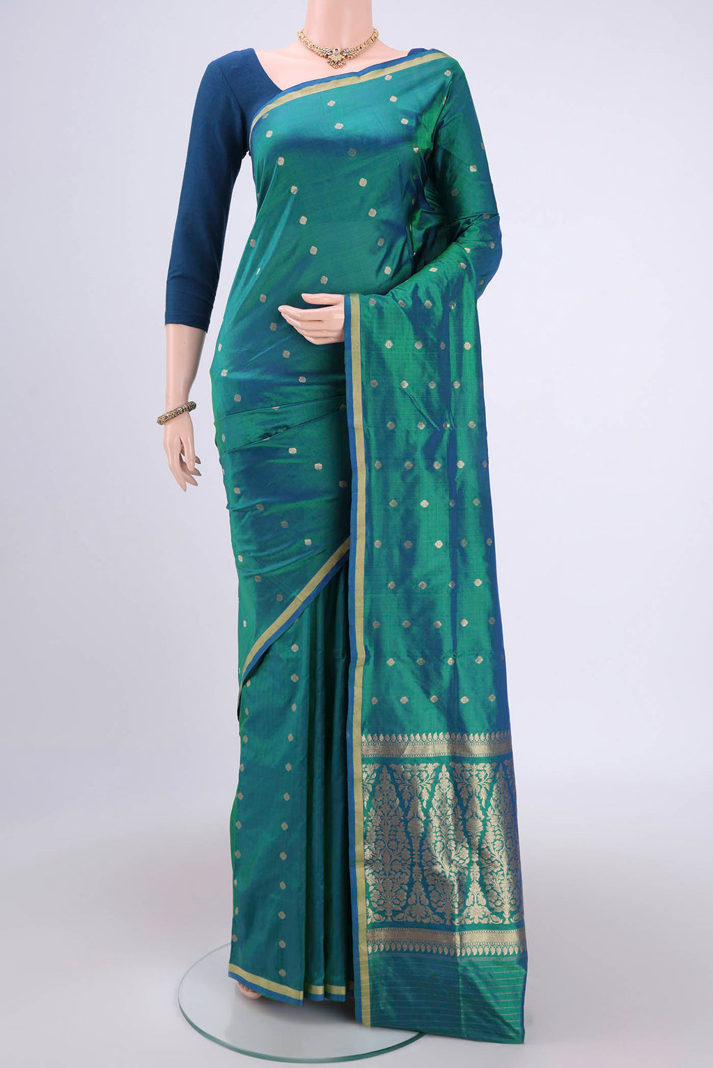 Turquoise Banarasi Katan Silk Saree with Zari Butta on the body and Zari Border.  displayed on a mannequin