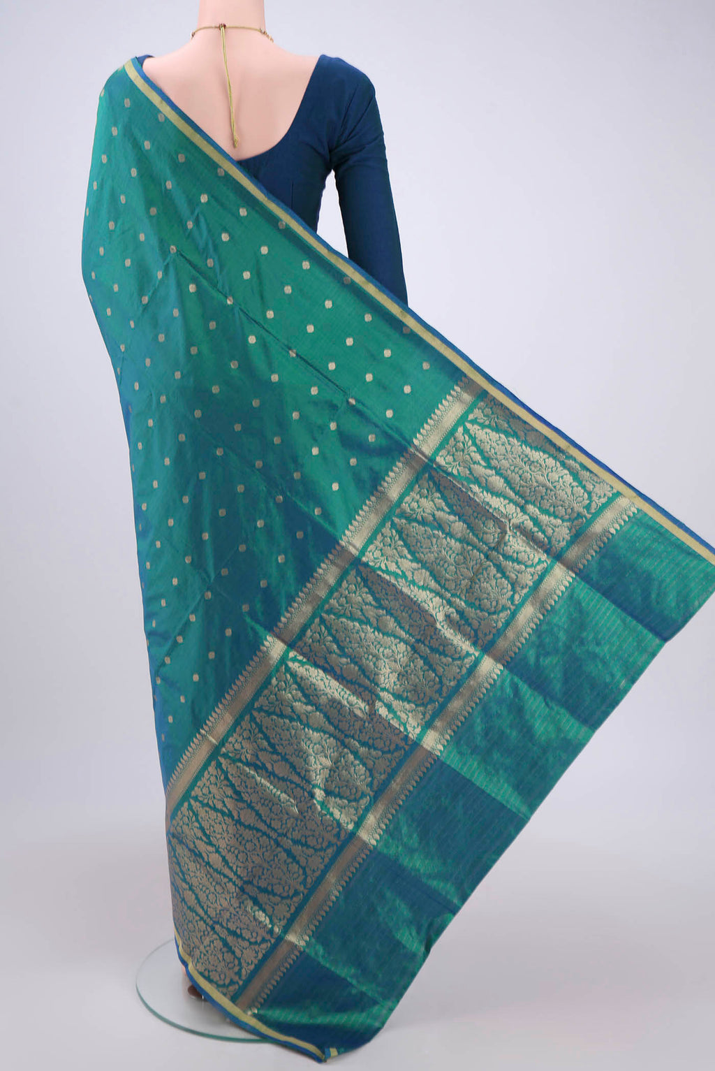 Flat view of Turquoise Banarasi Katan Silk Saree with Zari Butta on the body and Zari Border. 