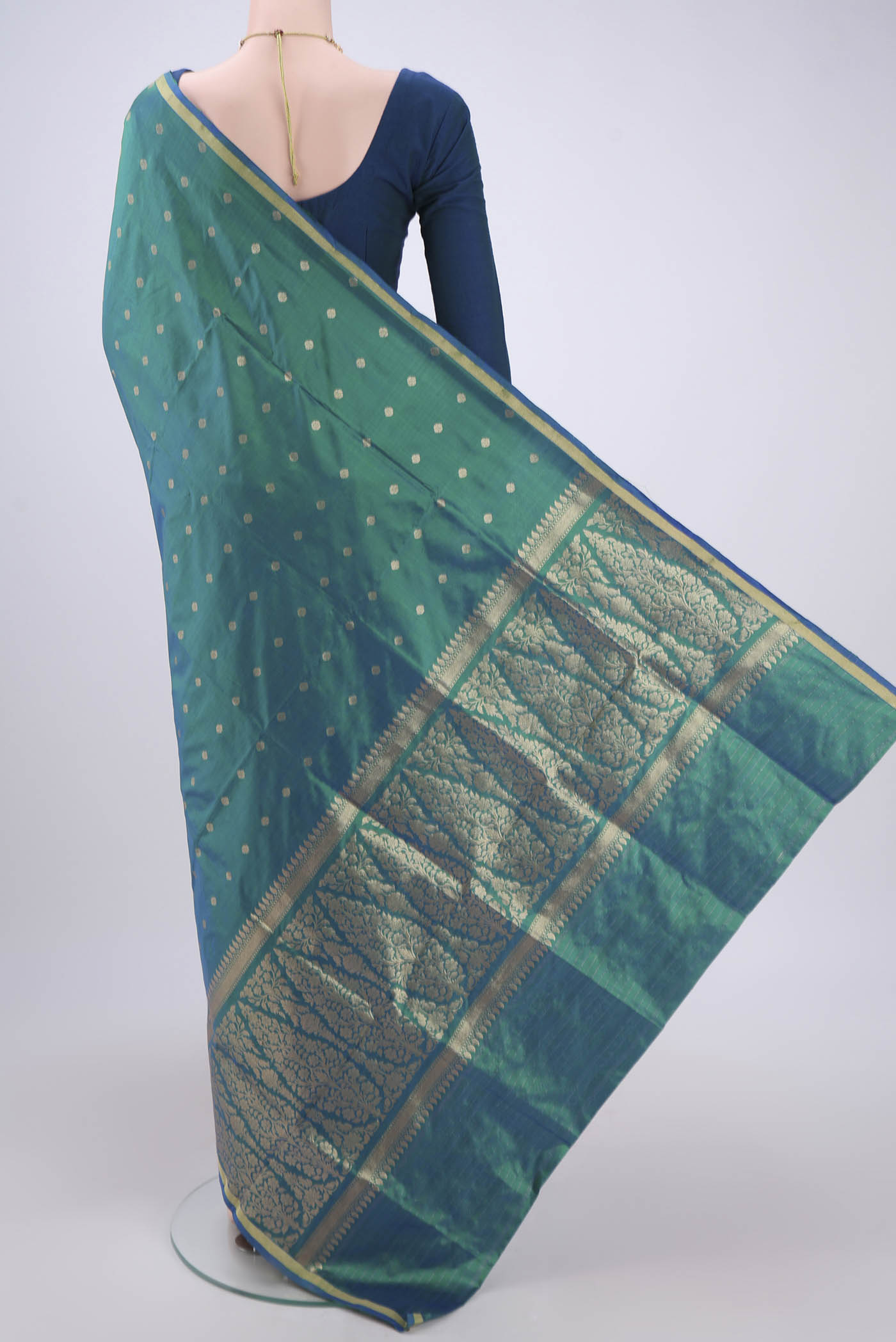 Flat view of Turquoise Banarasi Katan Silk Saree with Zari Butta on the body and Zari Border. 