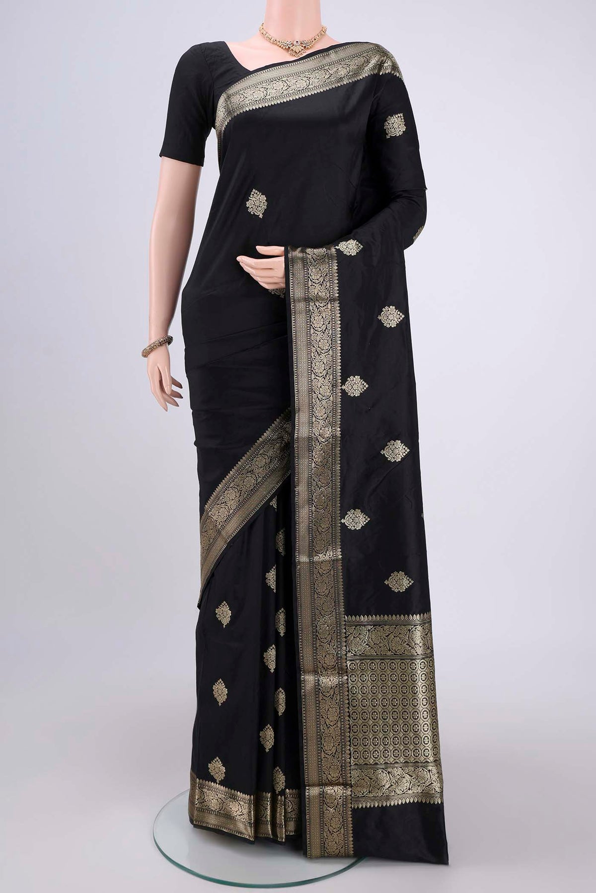 Black Banarasi Katan Silk Saree with Zari Butta on the body and Zari Border.  displayed on a mannequin