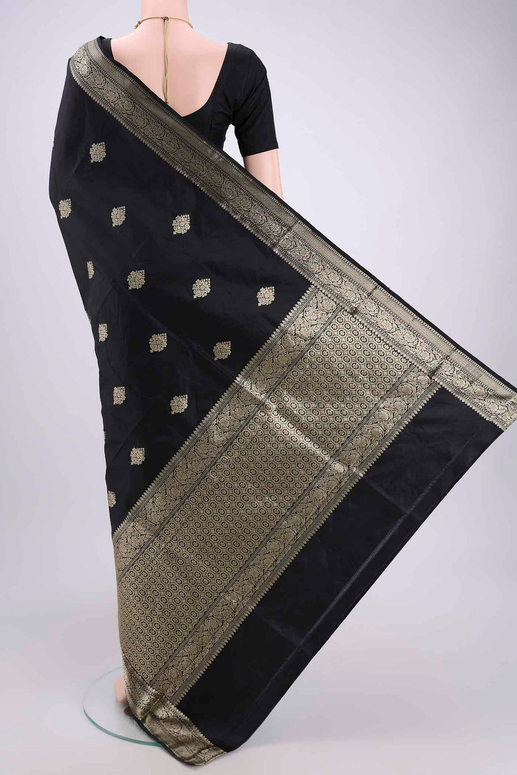 Flat view of Black Banarasi Katan Silk Saree with Zari Butta on the body and Zari Border. 