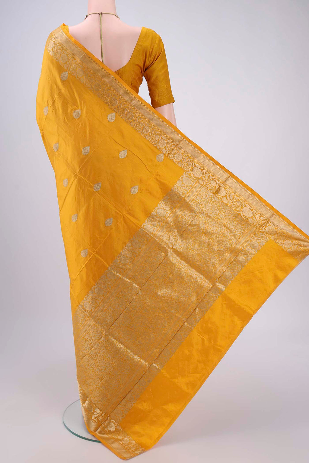 Flat view of Yellow Banarasi Katan Silk Saree with Zari Butta on the body and Zari Border. 