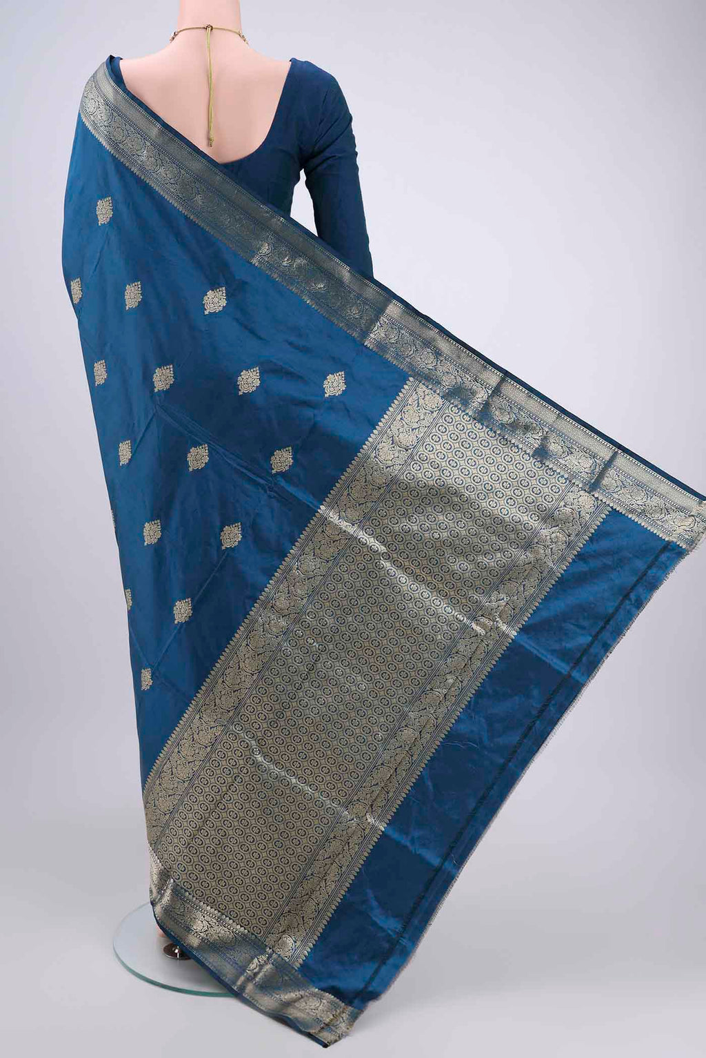 Flat view of Turquoise Banarasi Katan Silk Saree with Zari Butta on the body and Zari Border. 