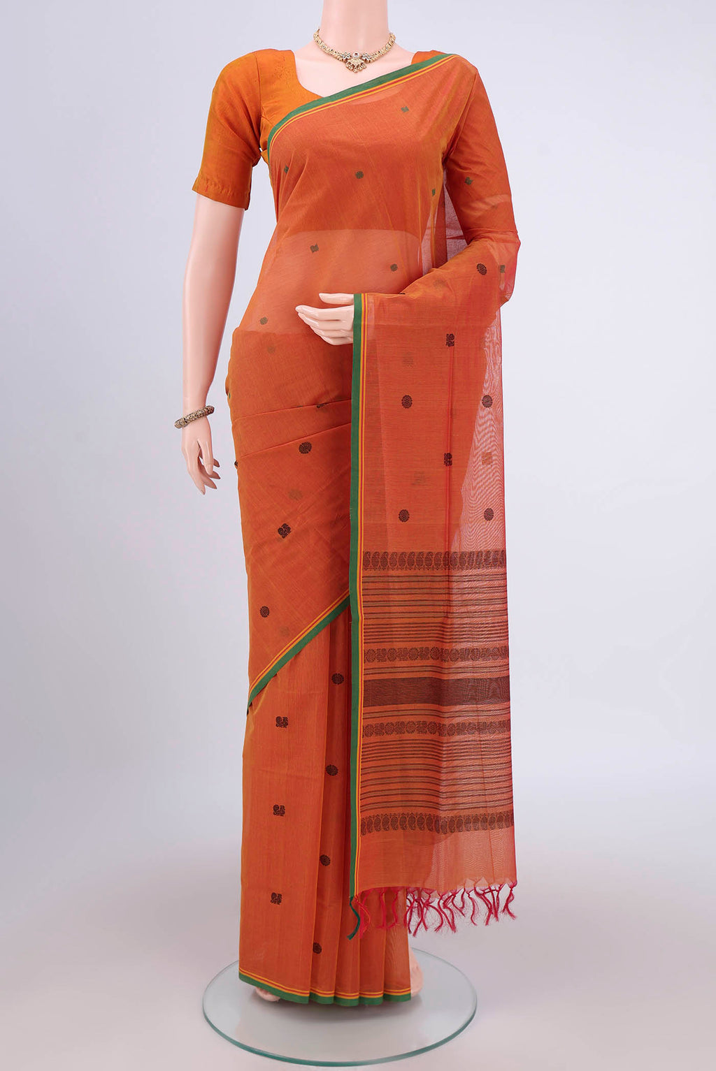 Mustard Coimbatore Cotton Saree with Thread Butta on the body and Zari Border.  displayed on a mannequin