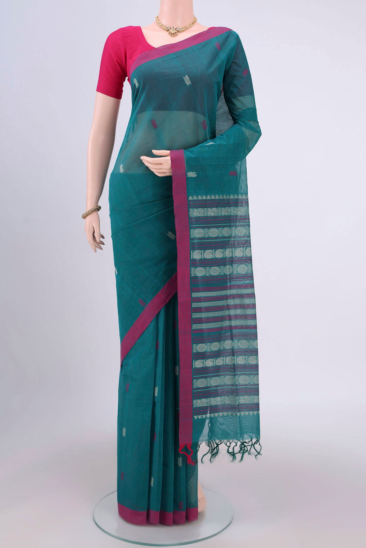 Sea Green Coimbatore Cotton Saree with Thread Butta on the body and Zari Border.  displayed on a mannequin