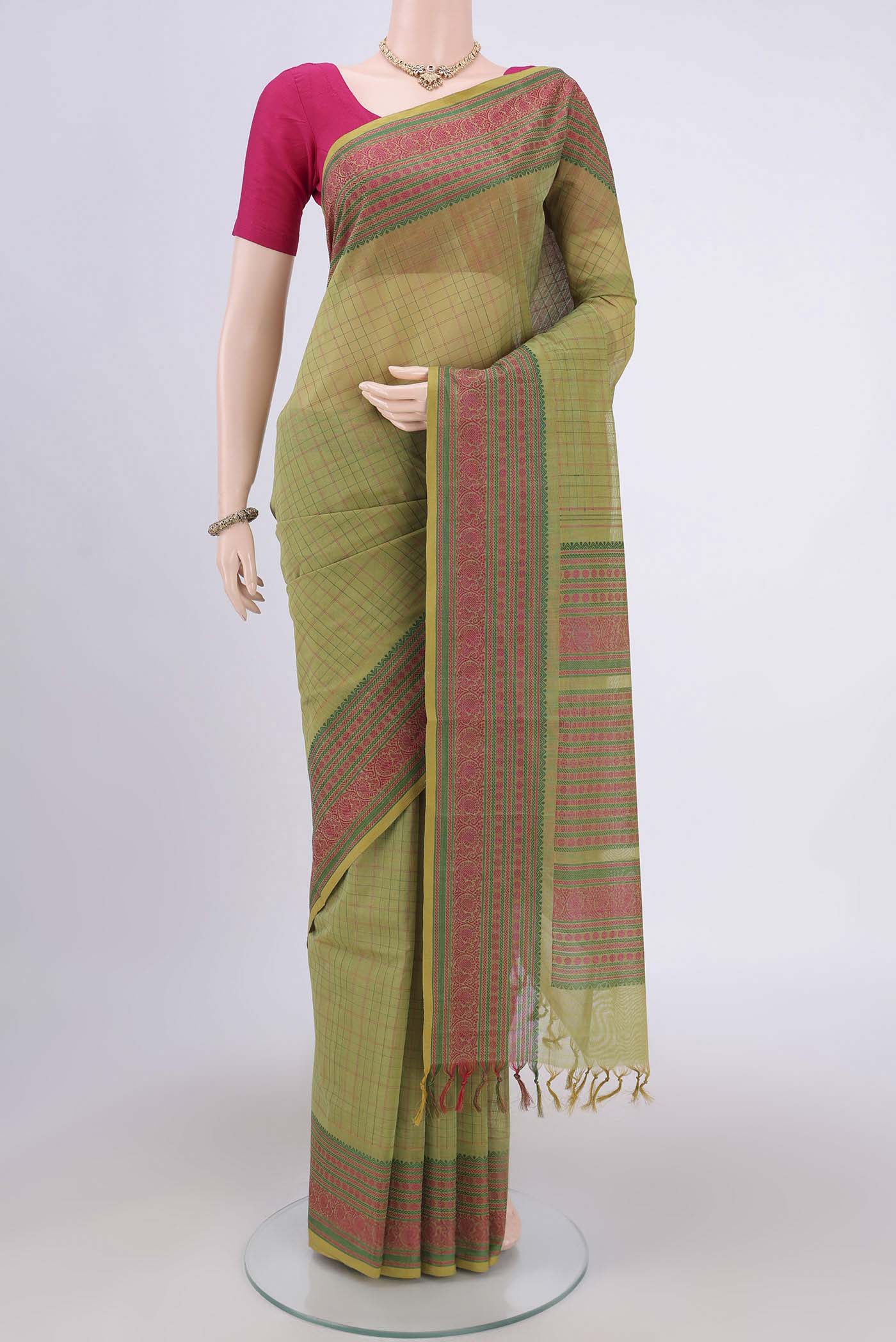 Mehandi Green Coimbatore Cotton Saree with Checked design on the body and Zari Border.  displayed on a mannequin