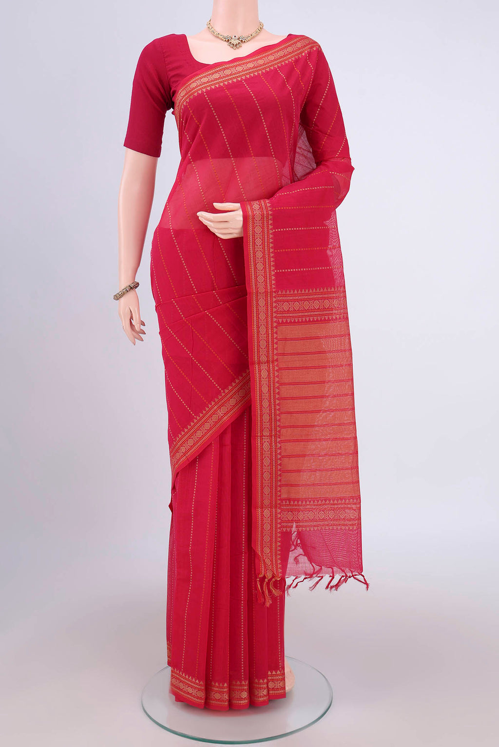Dark Pink Kanchi Cotton Saree with Stripes on the body and Zari Border.  displayed on a mannequin