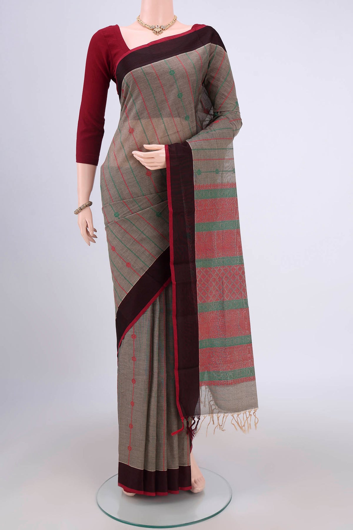 Grey Coimbatore Cotton Saree with Stripes on the body and Zari Border.  displayed on a mannequin
