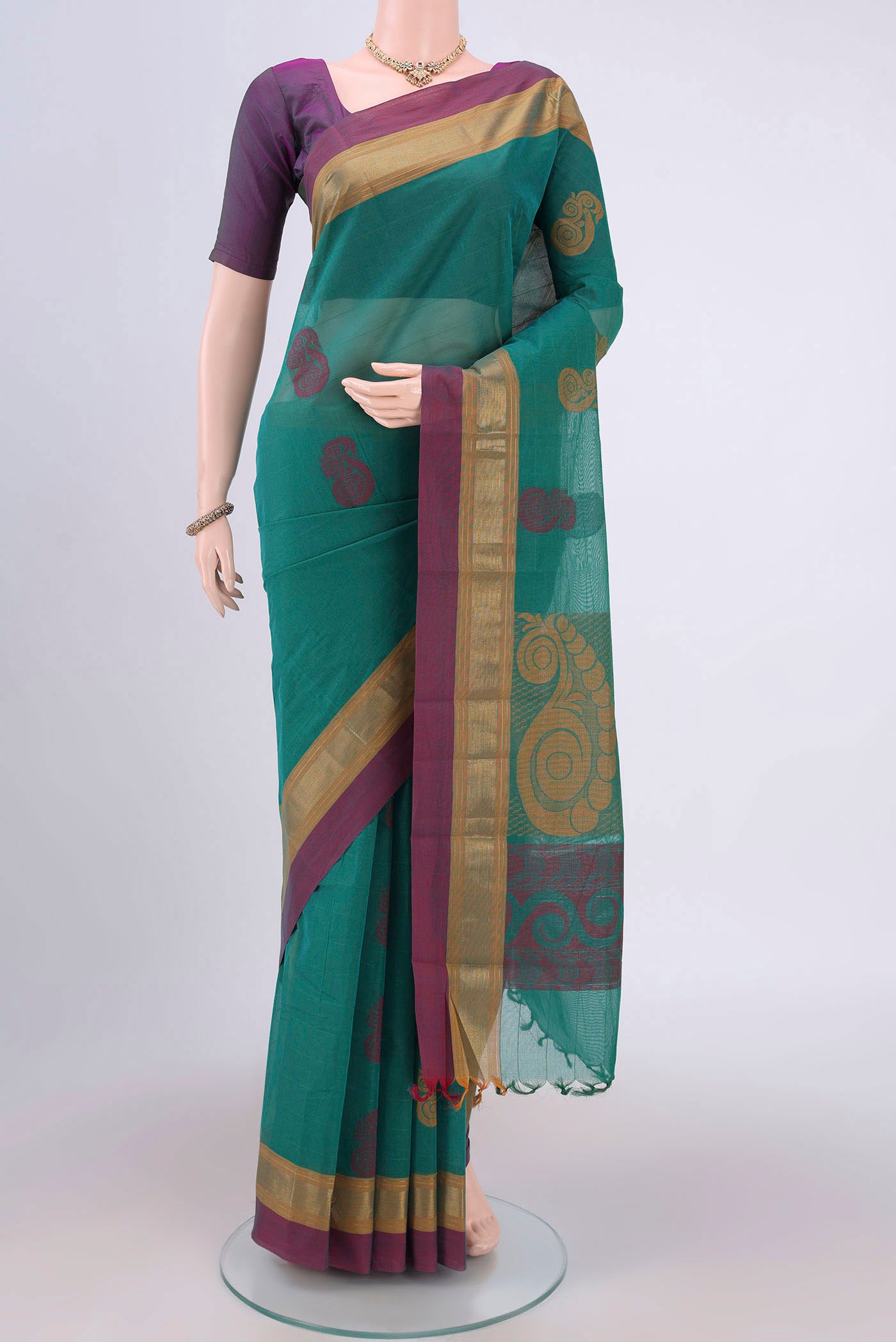 Green Kanchi Cotton Saree with Thread Butta on the body and Zari Border.  displayed on a mannequin