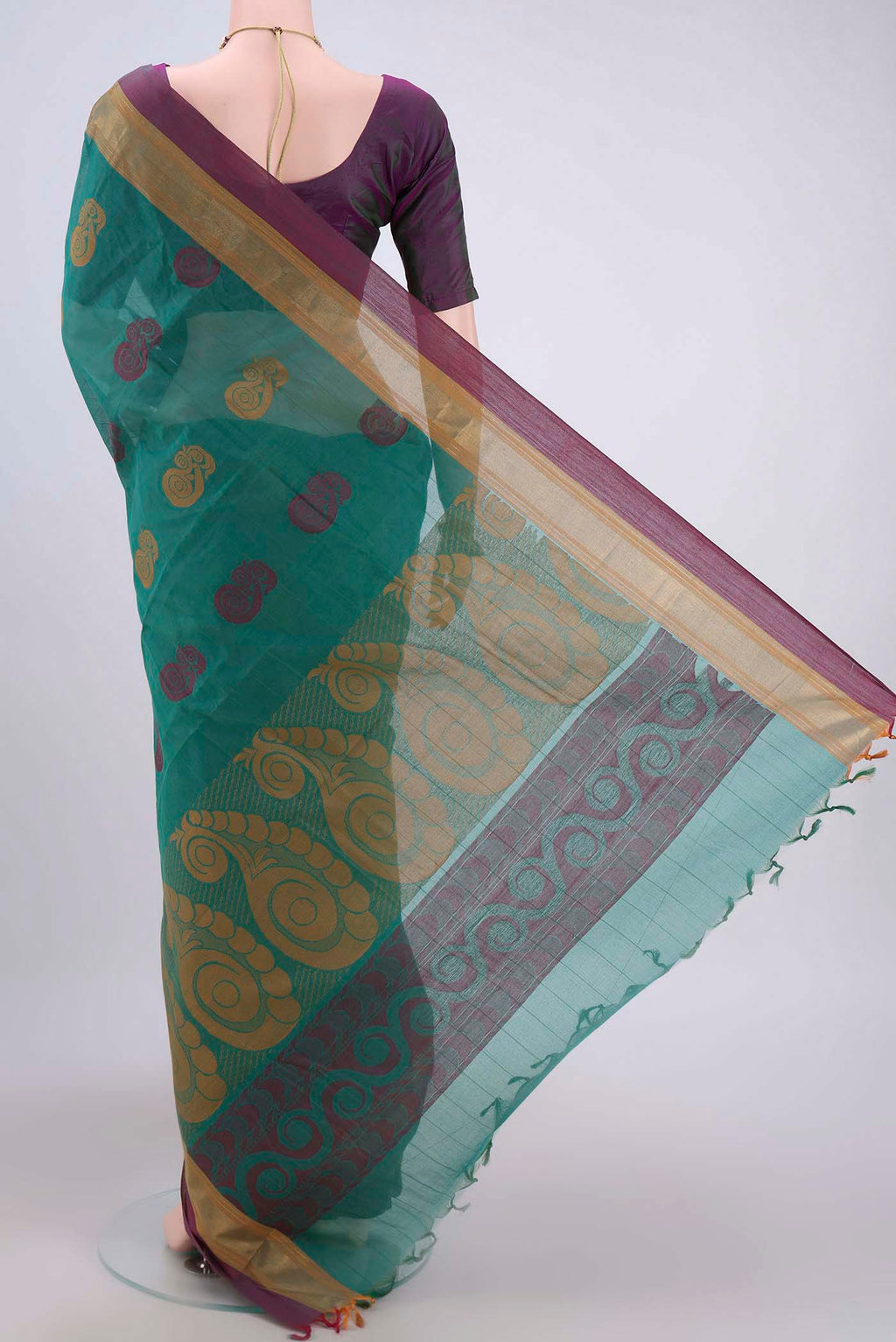 Flat view of Green Kanchi Cotton Saree with Thread Butta on the body and Zari Border. 