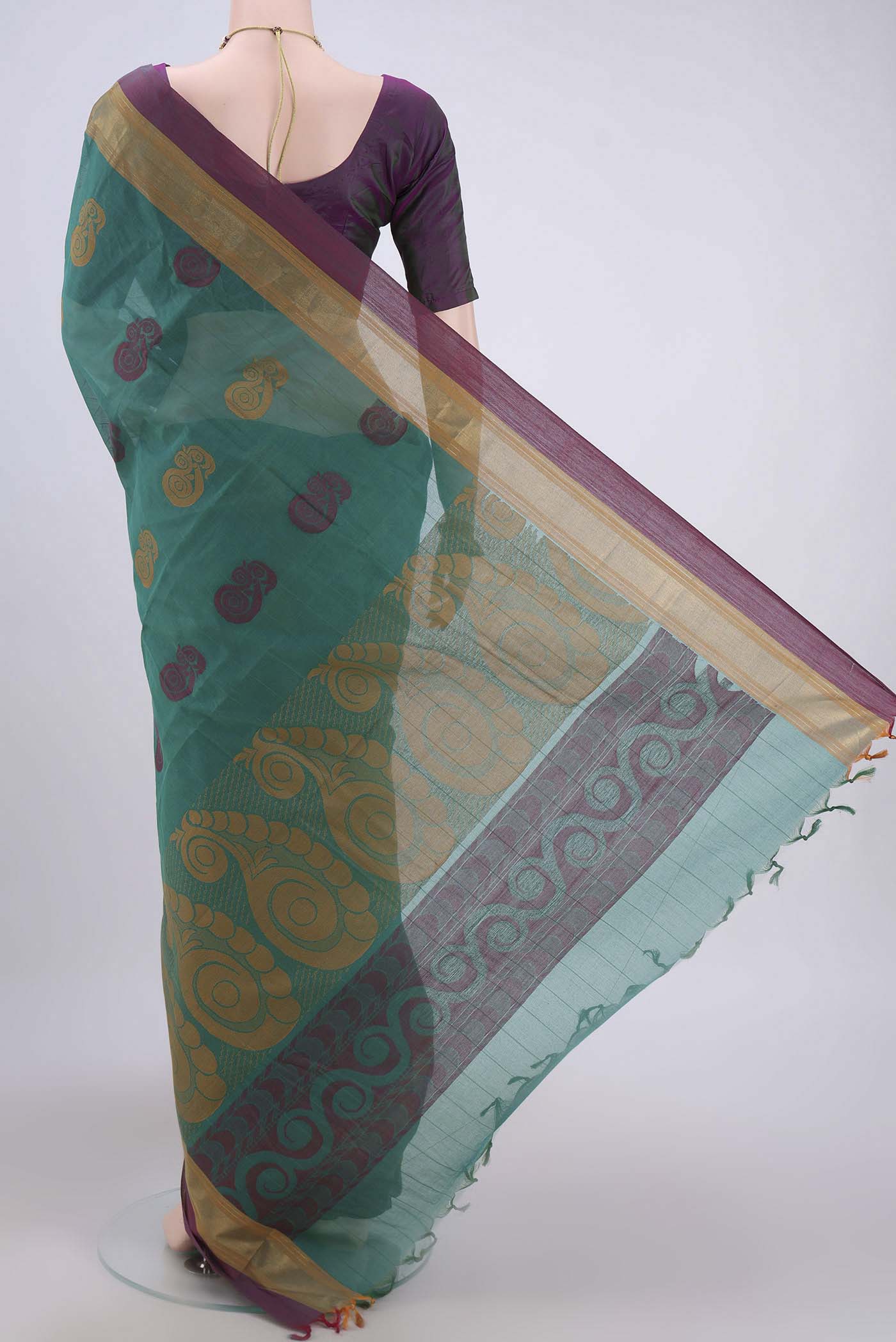 Flat view of Green Kanchi Cotton Saree with Thread Butta on the body and Zari Border. 