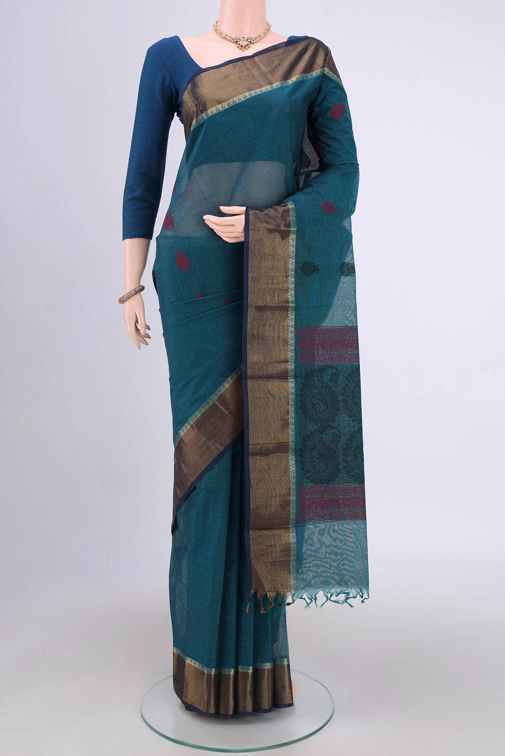 Blue Kanchi Cotton Saree with Thread Butta on the body and Zari Border.  displayed on a mannequin