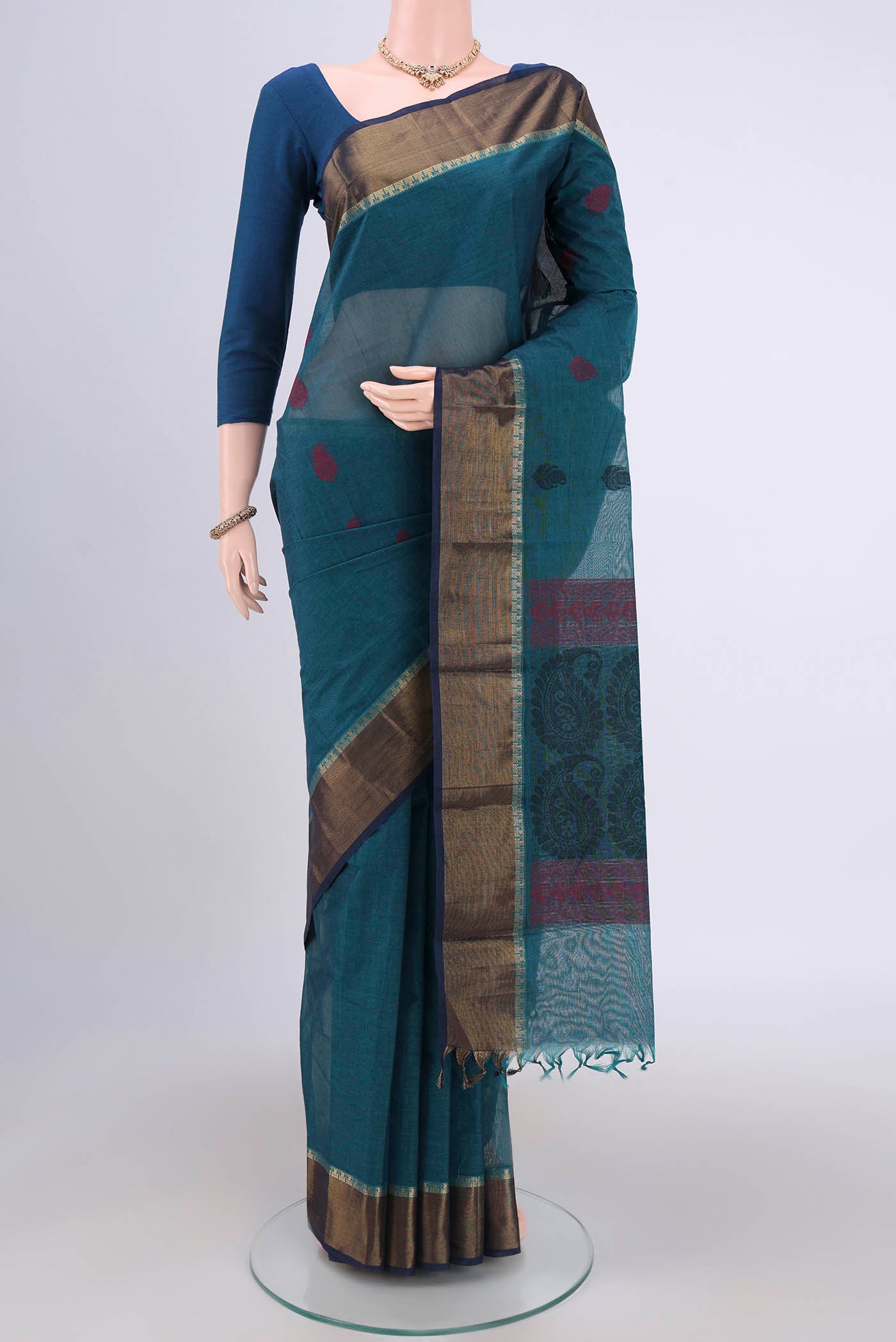 Blue Kanchi Cotton Saree with Thread Butta on the body and Zari Border.  displayed on a mannequin
