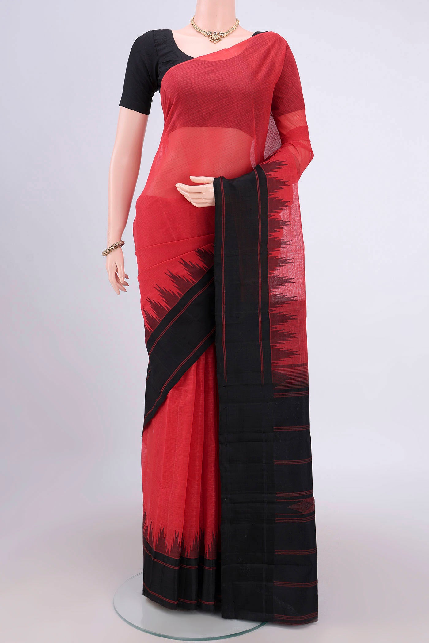 Peach Kanchi Cotton Saree with Plain Body and Zari Border.  displayed on a mannequin