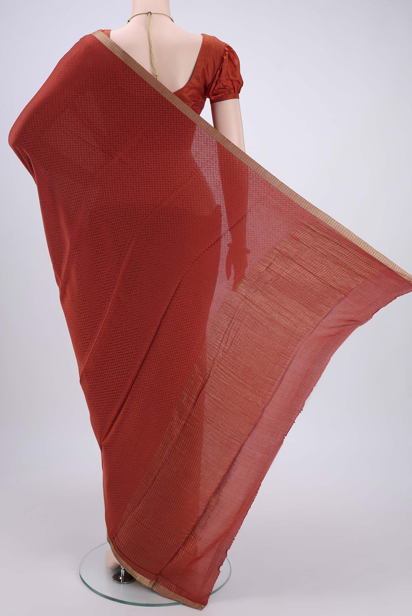 Flat view of Rust Mysore Crepe Saree with Jacquard design on the body and Zari Border. 