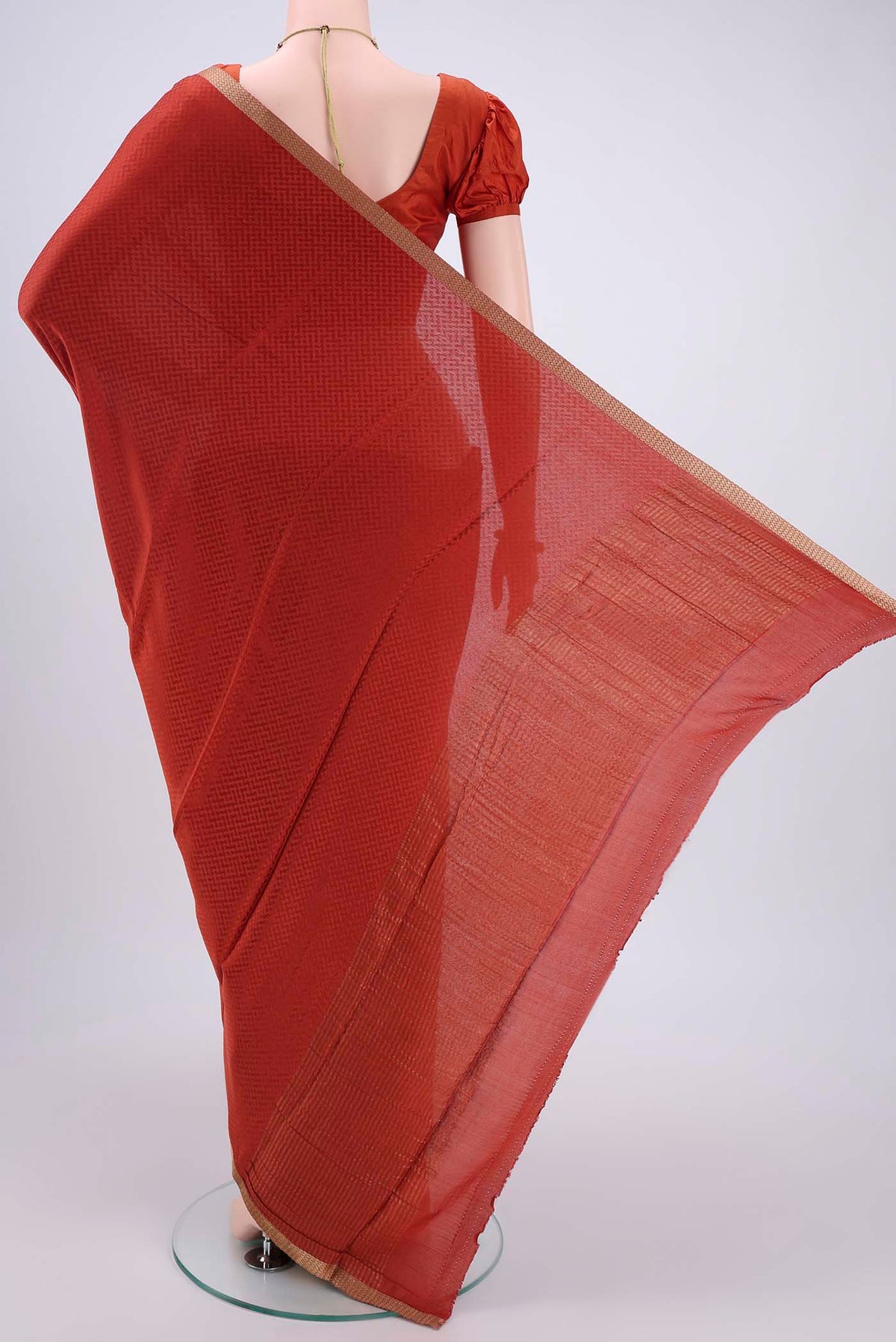 Flat view of Rust Mysore Crepe Saree with Jacquard design on the body and Zari Border. 