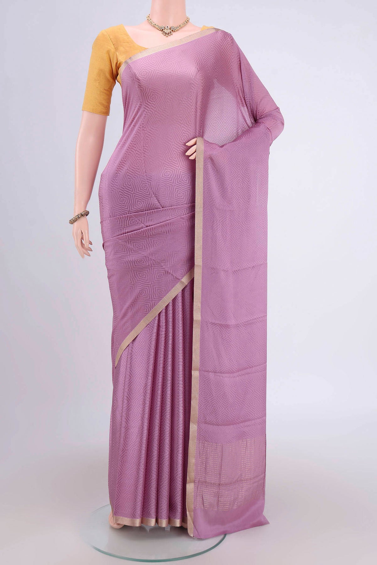 Mauve Mysore Crepe Saree with Jacquard design on the body and Zari Border.  displayed on a mannequin