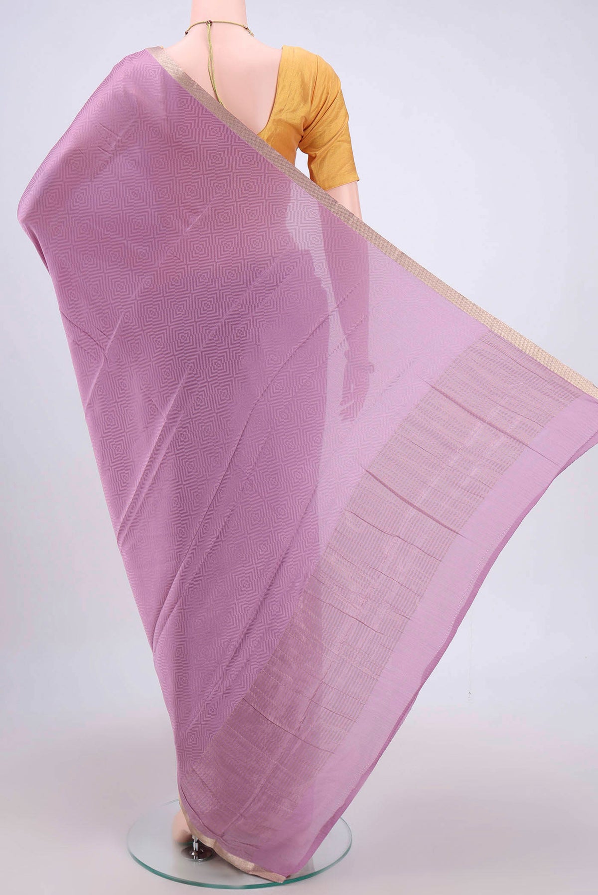 Flat view of Mauve Mysore Crepe Saree with Jacquard design on the body and Zari Border. 