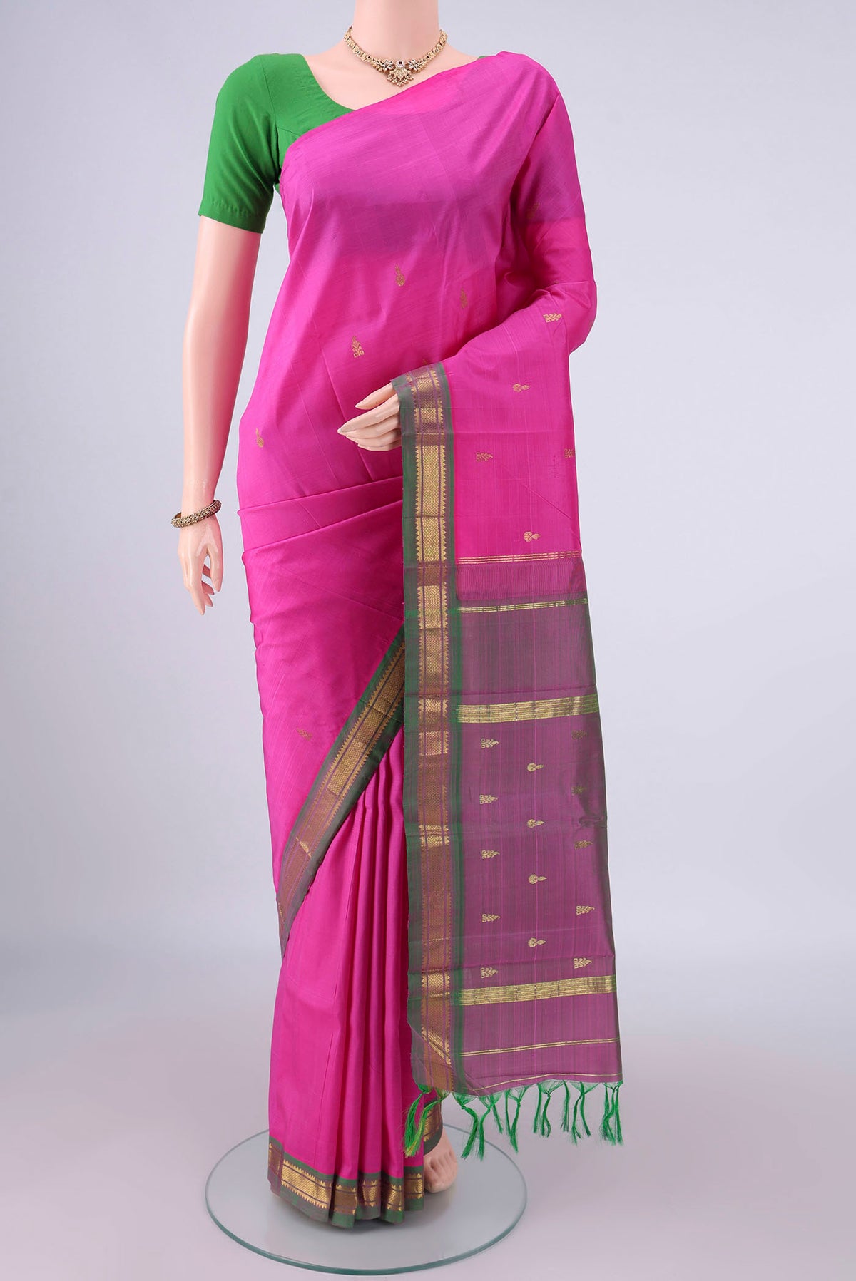 Pure Silk Pink Kanchipuram Saree with Zari Butta on the body and Zari Border.  displayed on a mannequin
