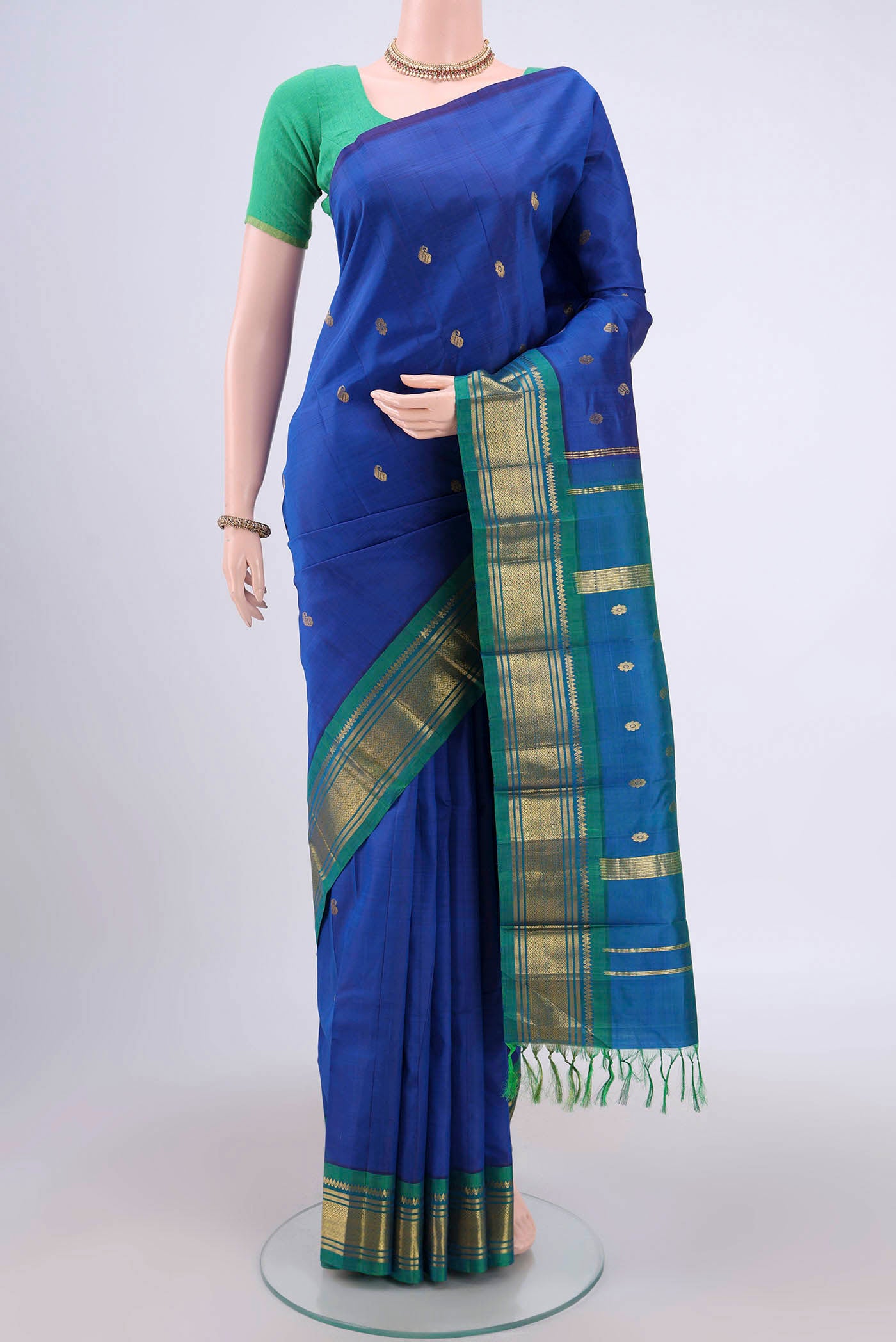 Dark Blue Dual Tone Kanjivaram Silk Saree with Zari Butta on the body and One Side Border.  displayed on a mannequin