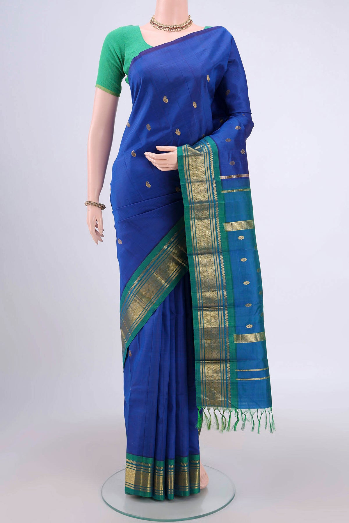 Dark Blue Dual Tone Kanjivaram Silk Saree with Zari Butta on the body and One Side Border.  displayed on a mannequin