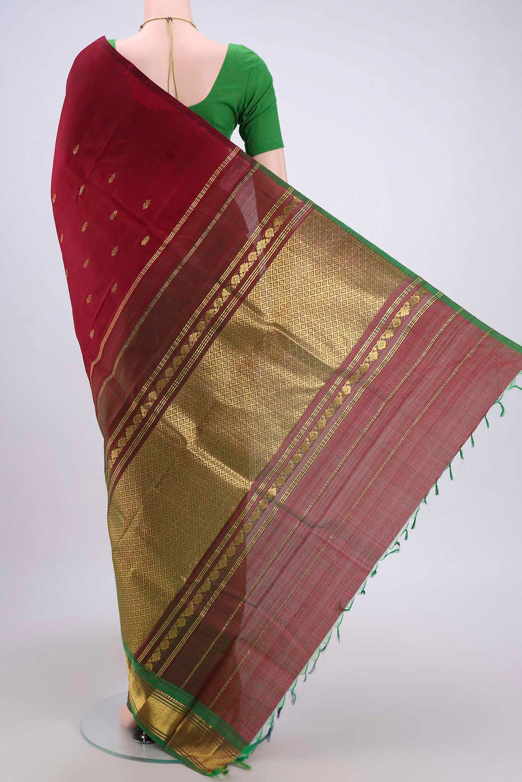 Flat view of Maroon Kanjivaram Silk Saree with Zari Butta on the body and One Side Border. 