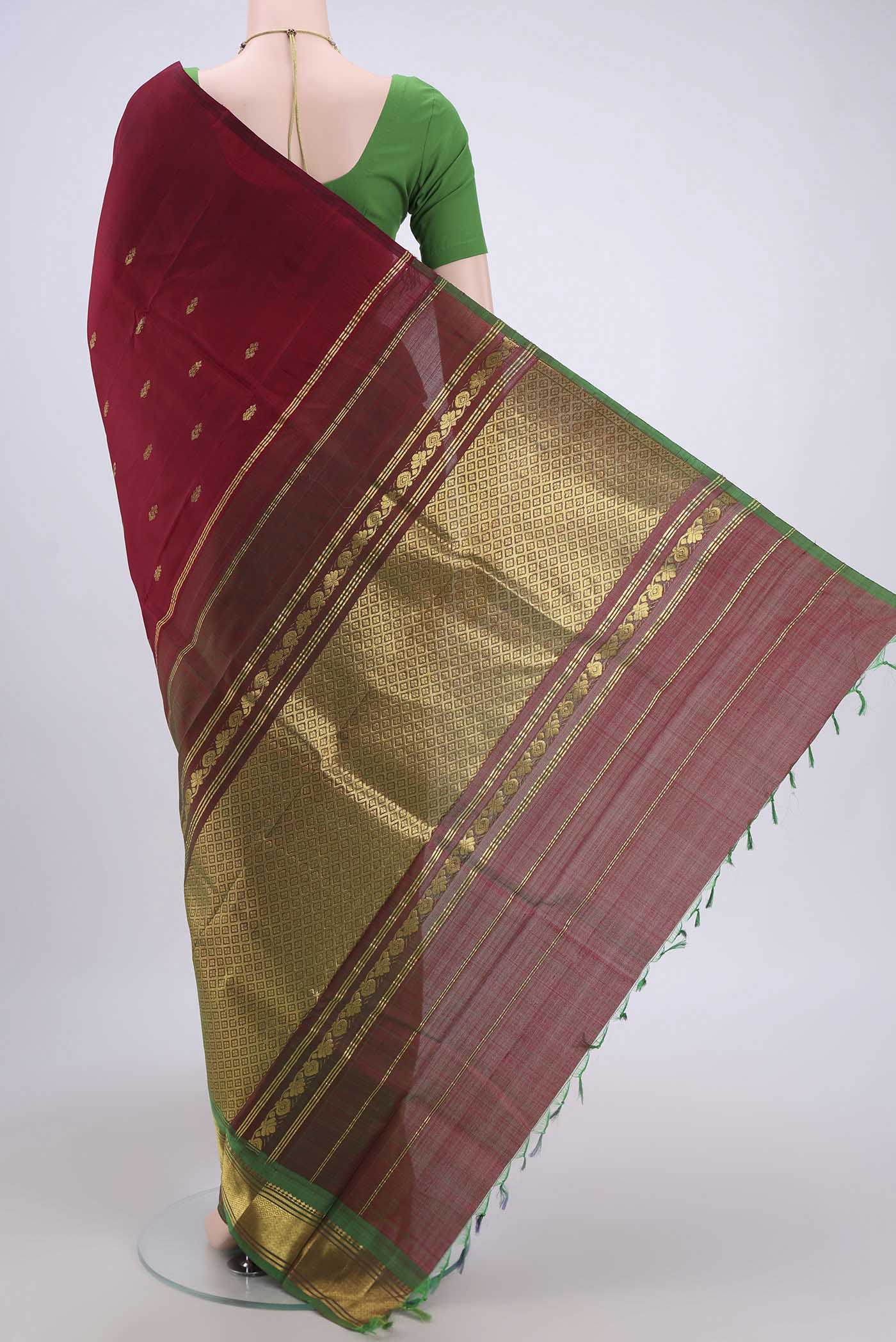 Flat view of Maroon Kanjivaram Silk Saree with Zari Butta on the body and One Side Border. 