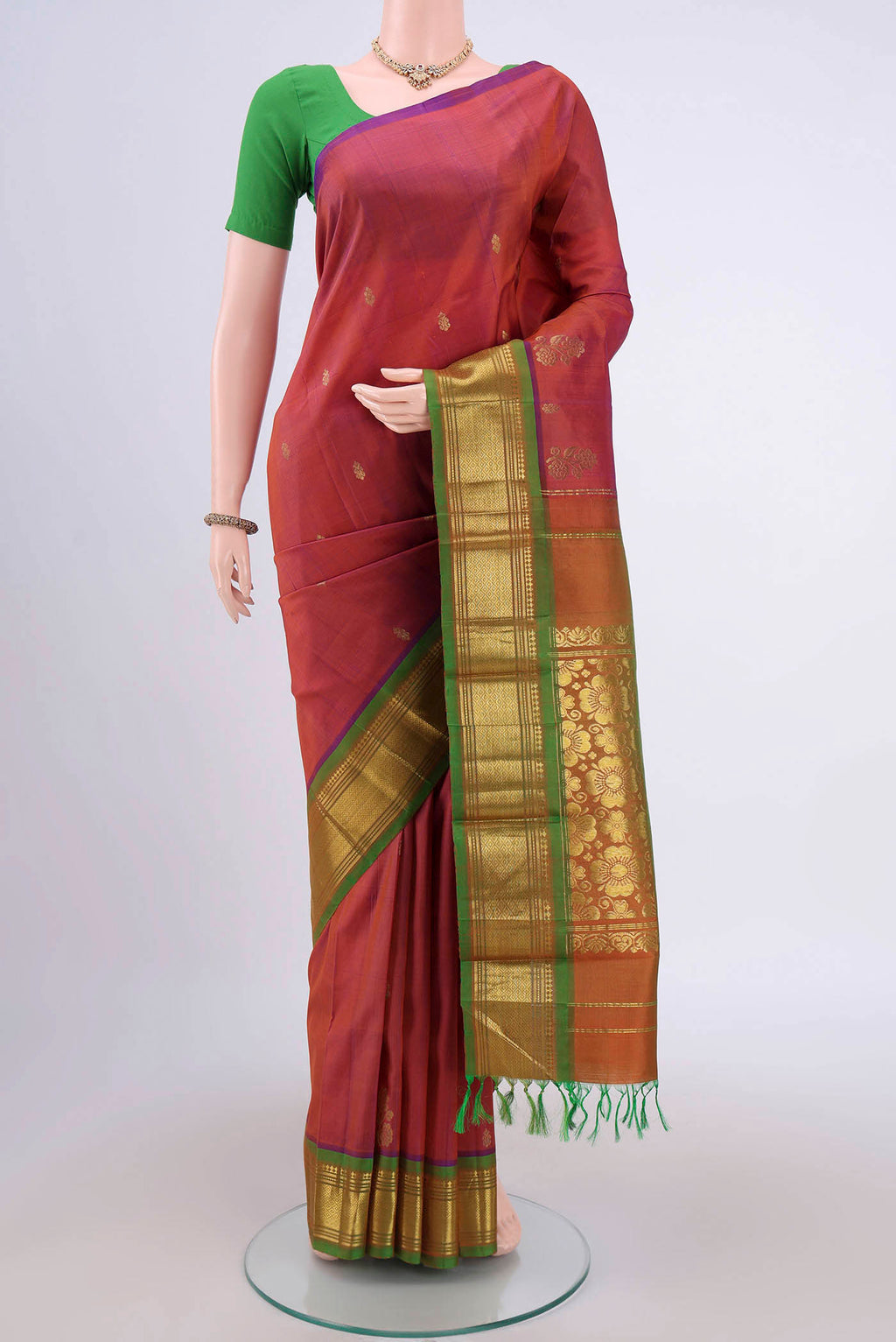 Rust Dual Tone Kanjivaram Silk Saree with Zari Butta on the body and One Side Border.  displayed on a mannequin