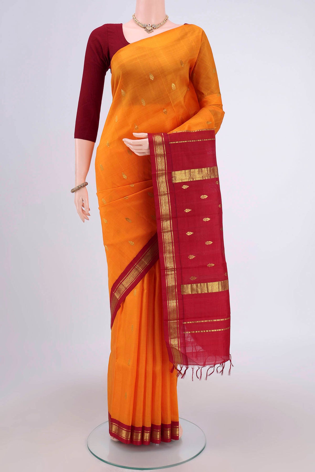 Yellow Dual Tone Kanjivaram Silk Saree with Zari Butta on the body and One Side Border.  displayed on a mannequin