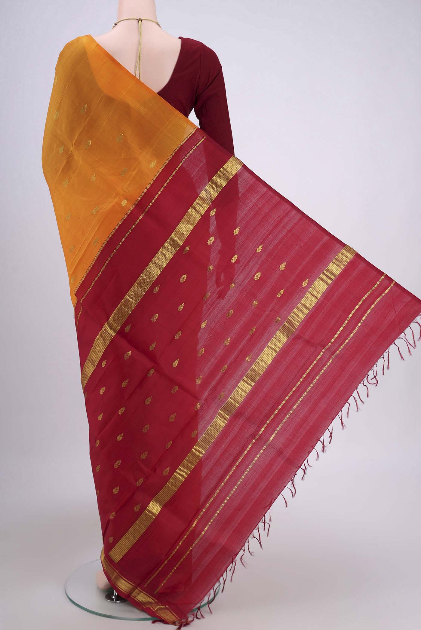 Flat view of Yellow Dual Tone Kanjivaram Silk Saree with Zari Butta on the body and One Side Border. 