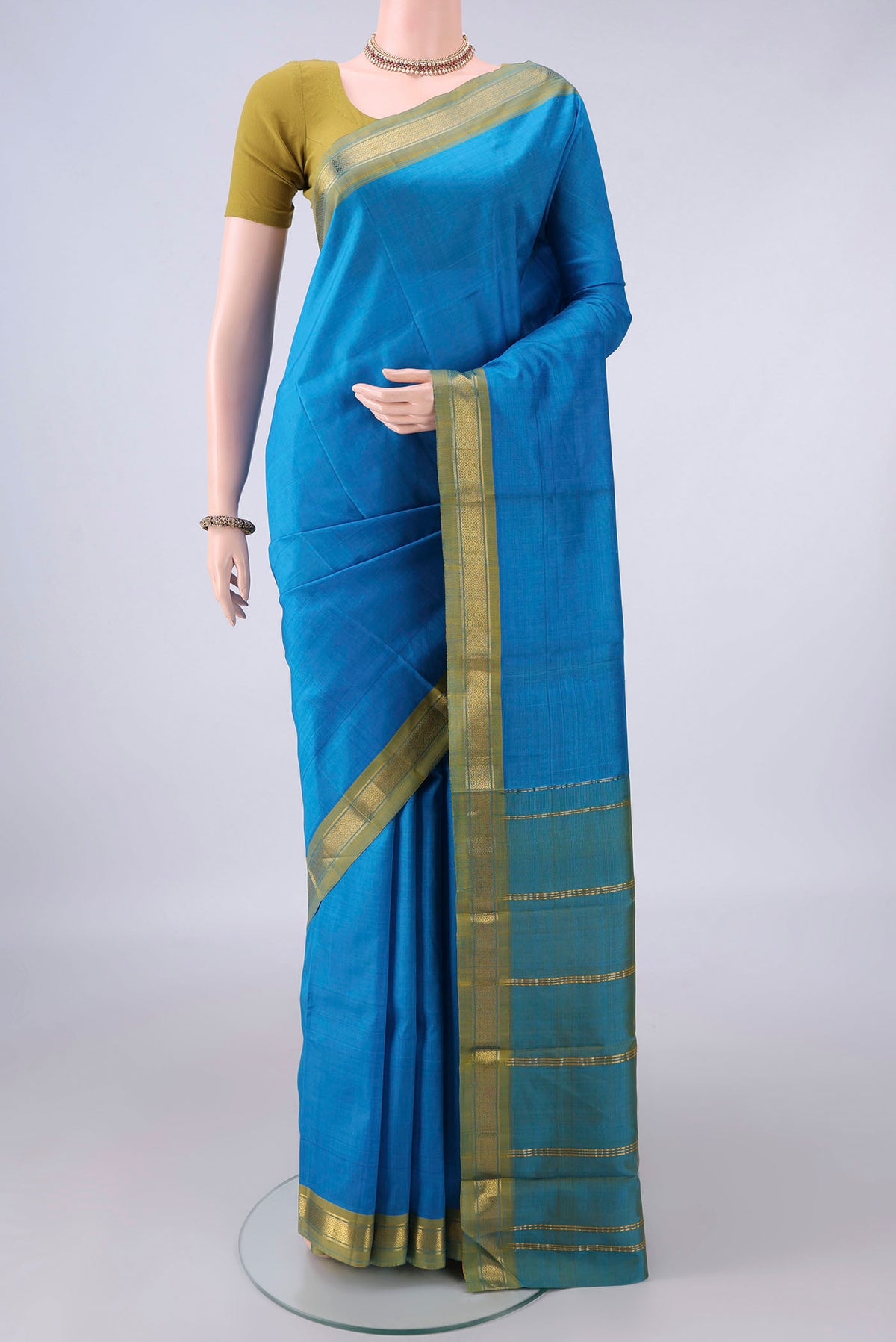 Pure Silk Electric Blue Kanjivaram Saree with Plain Body and Zari Border.  displayed on a mannequin
