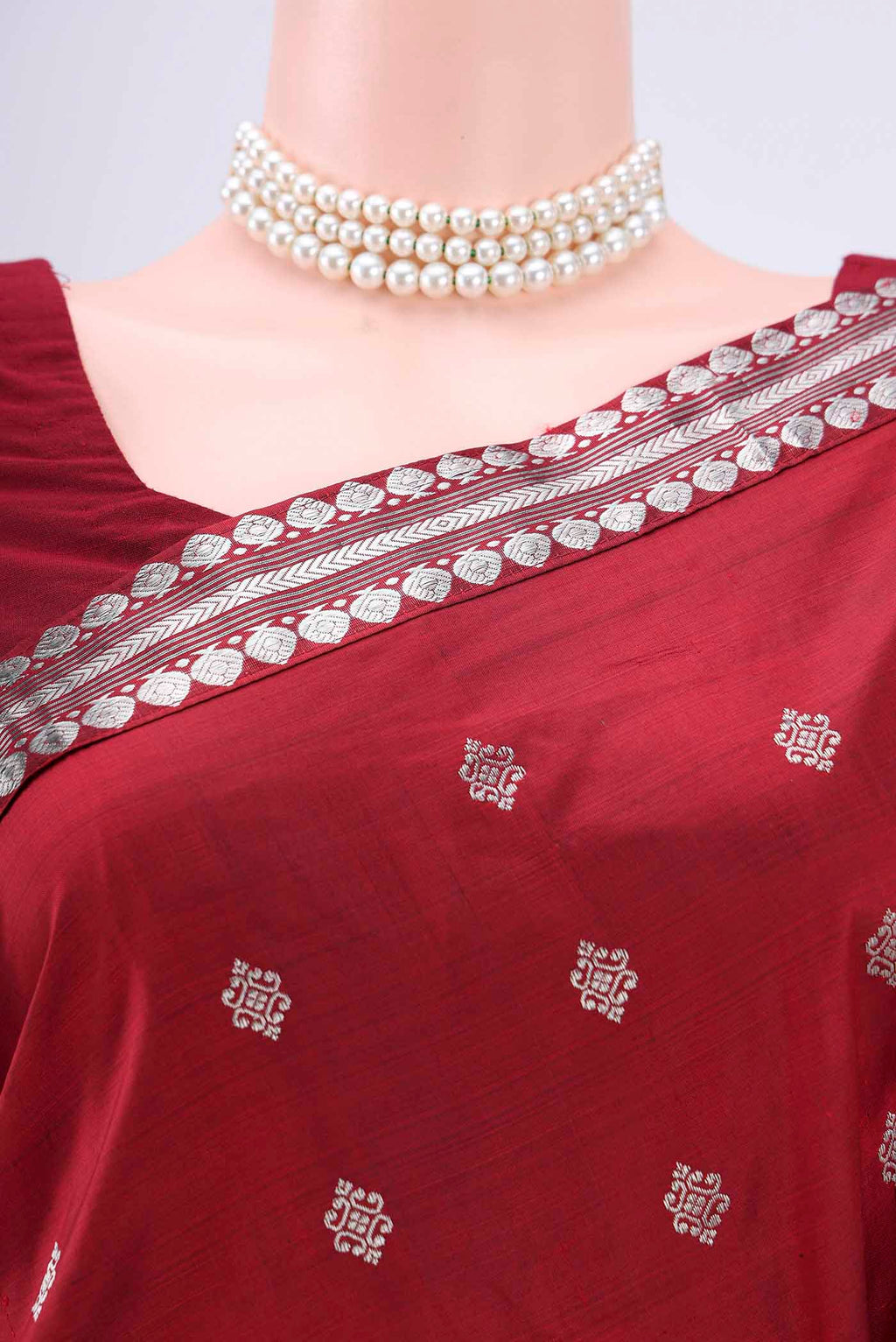 Border image of Maroon Assam Silk Saree with Zari Butta on the body and Zari Border. 