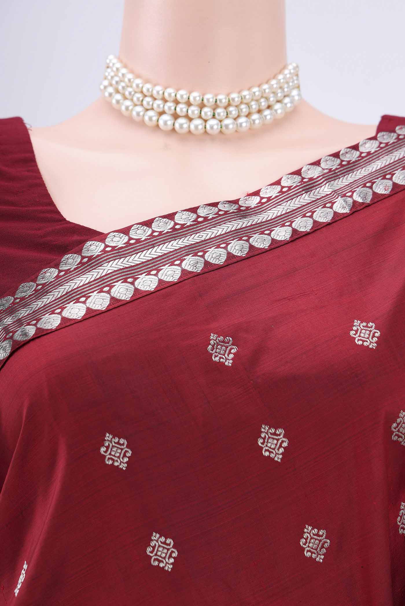 Border image of Maroon Assam Silk Saree with Zari Butta on the body and Zari Border. 