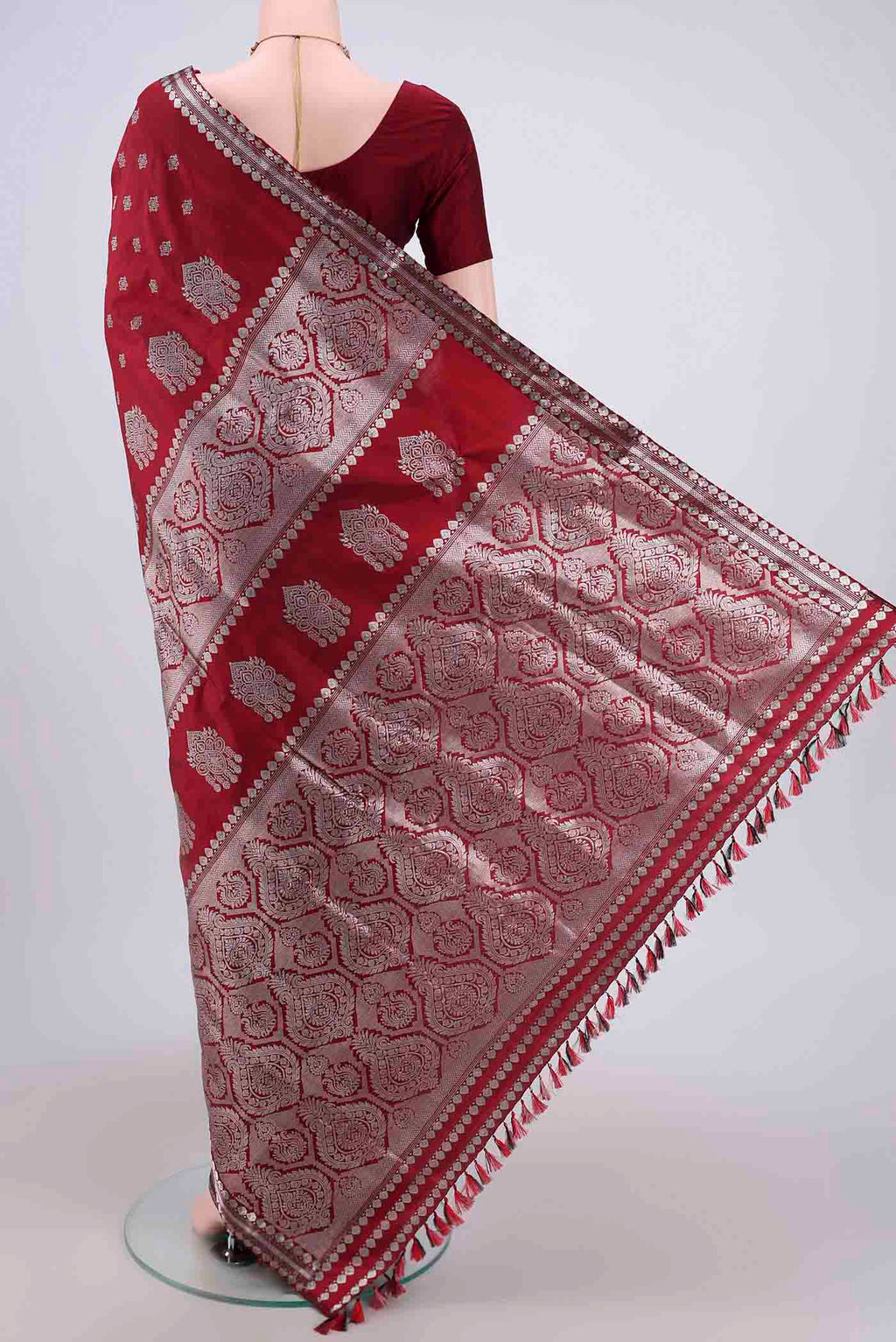 Flat view of Maroon Assam Silk Saree with Zari Butta on the body and Zari Border. 