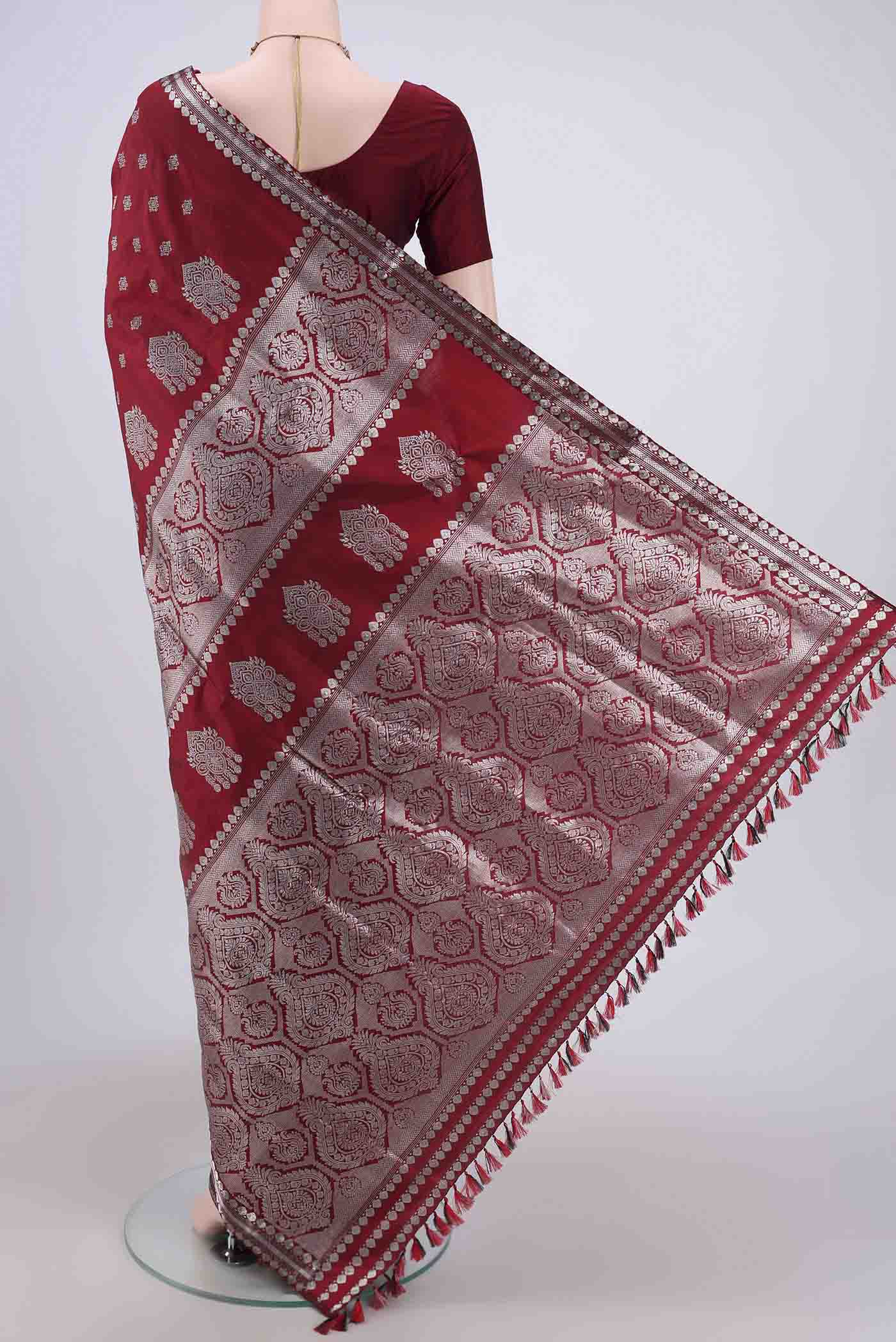 Flat view of Maroon Assam Silk Saree with Zari Butta on the body and Zari Border. 